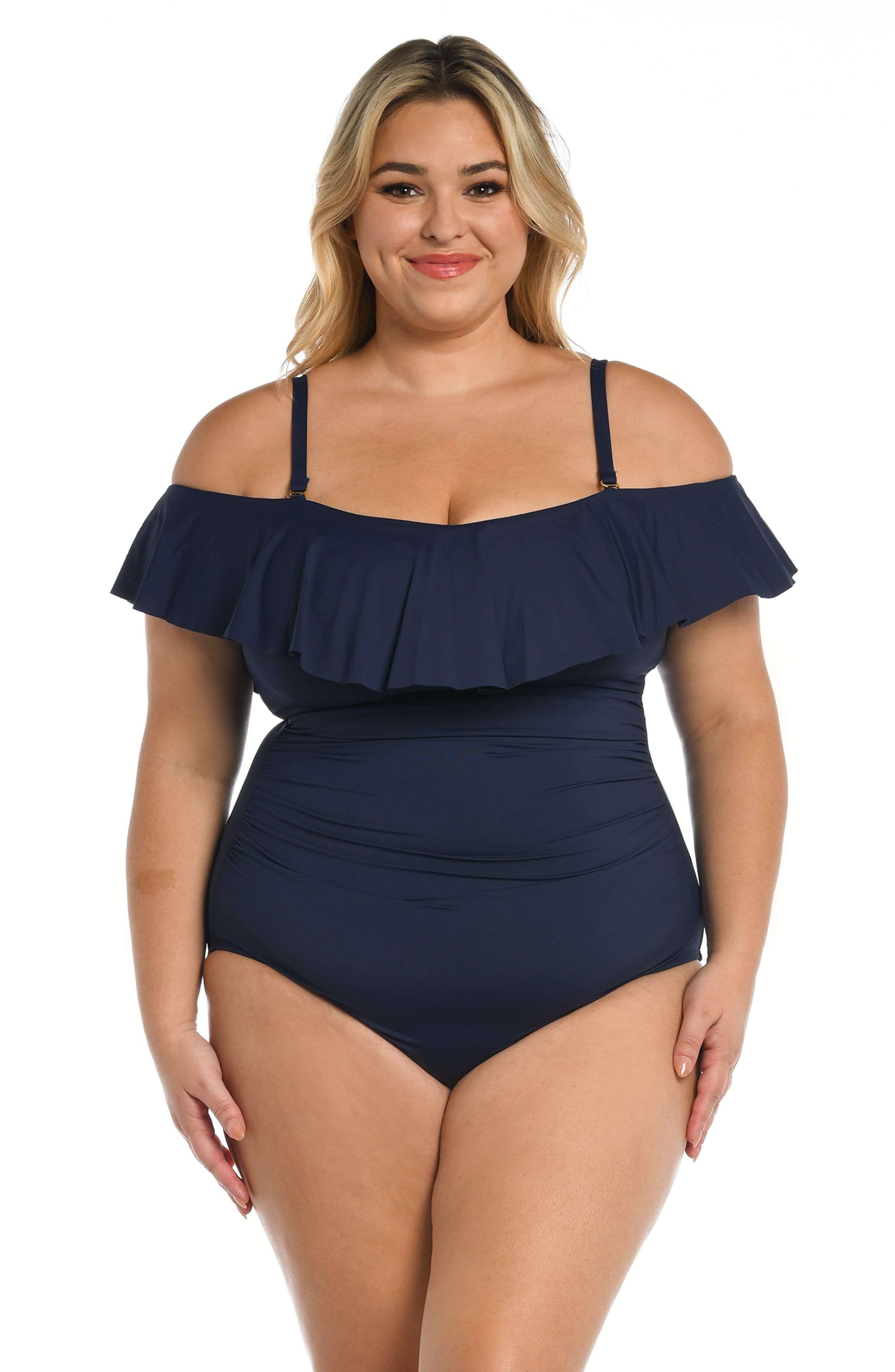 Woman wearing an indigo colored off-shoulder one piece swimsuit on a white background
