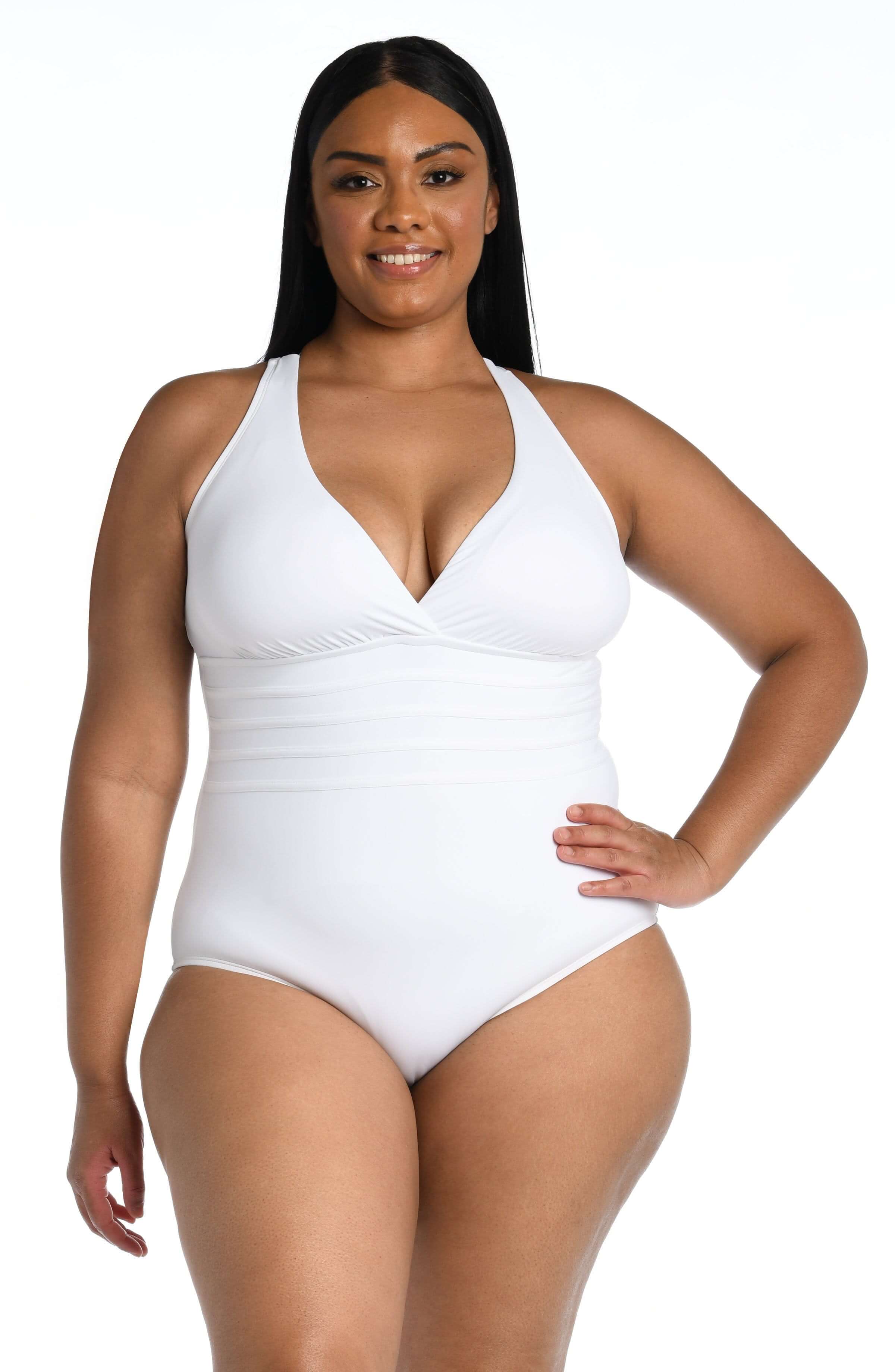 Woman wearing a white halter neck swimsuit on a white background