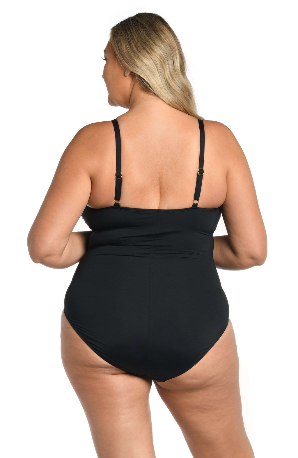 Woman wearing a black swimsuit against a white background