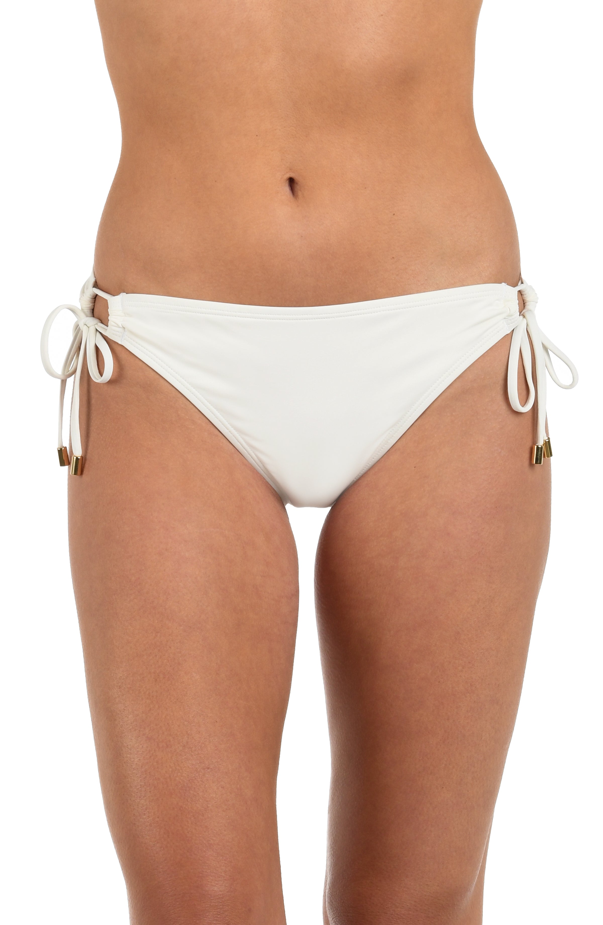 Front image of model wearing an ivory colored hipster bikini bottom featuring adjustable loop side ties with gold cord ends. 