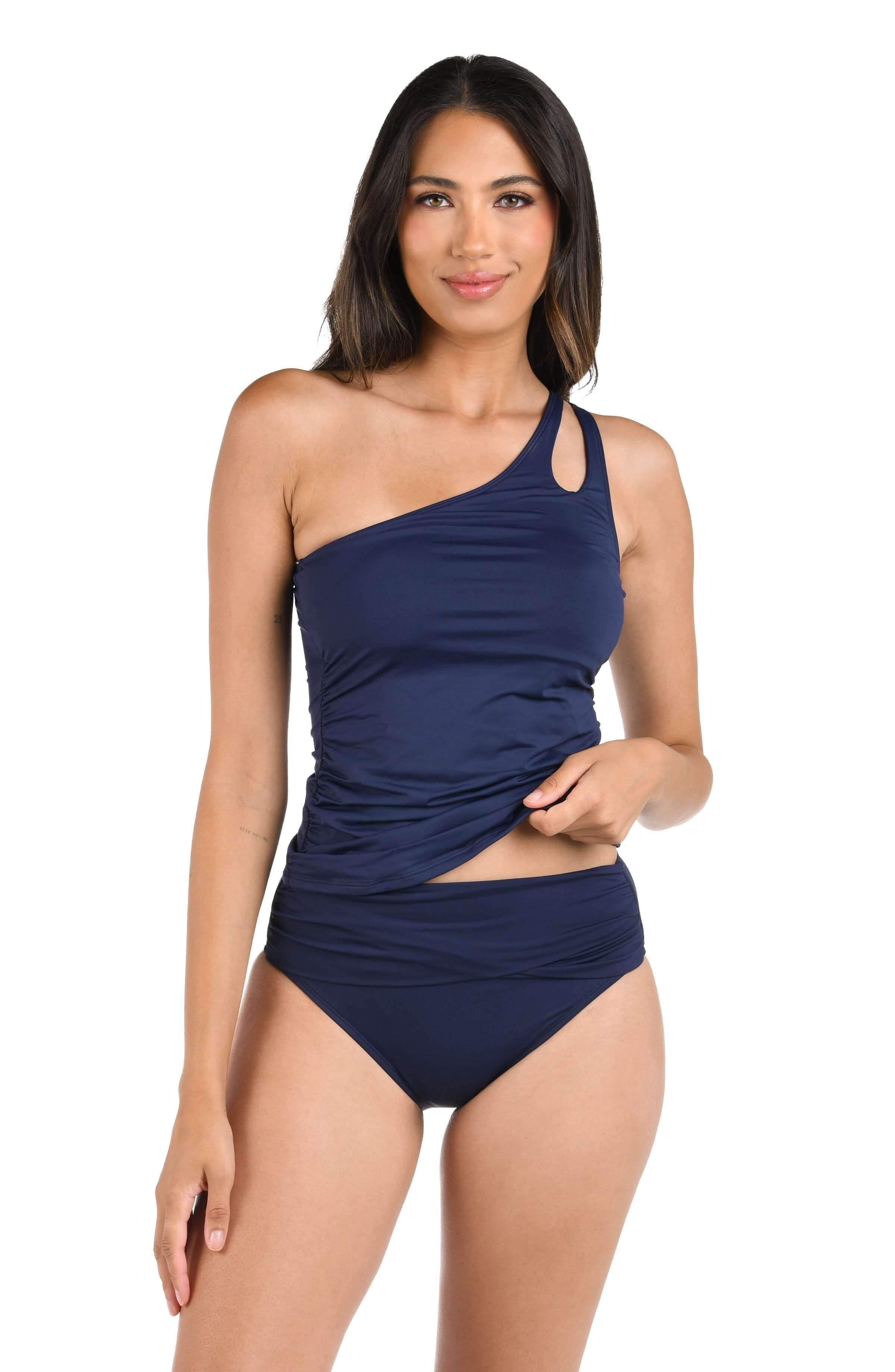 Woman wearing a navy blue one-shoulder swimsuit on a white background