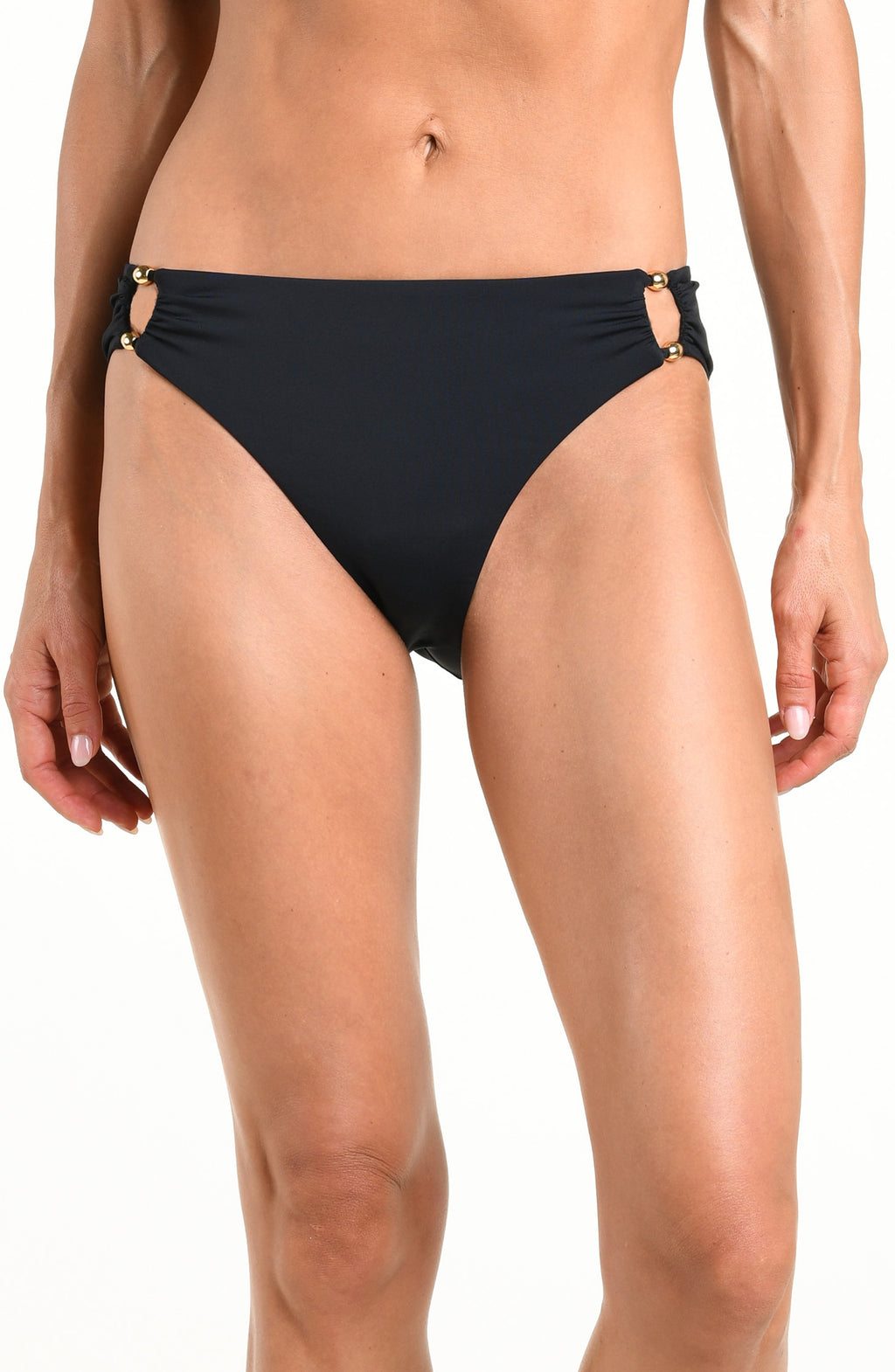 Woman wearing a solid black bikini bottom with beaded sides against a white background. 