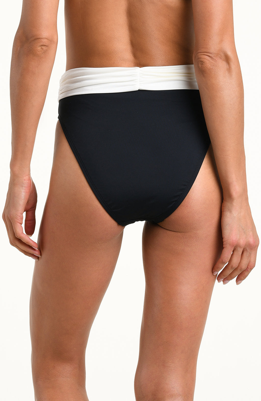 A close-up of a model wearing a pair of high-cut bikini bottoms with a solid black body and a contrasting white waistband, set against a plain white background.