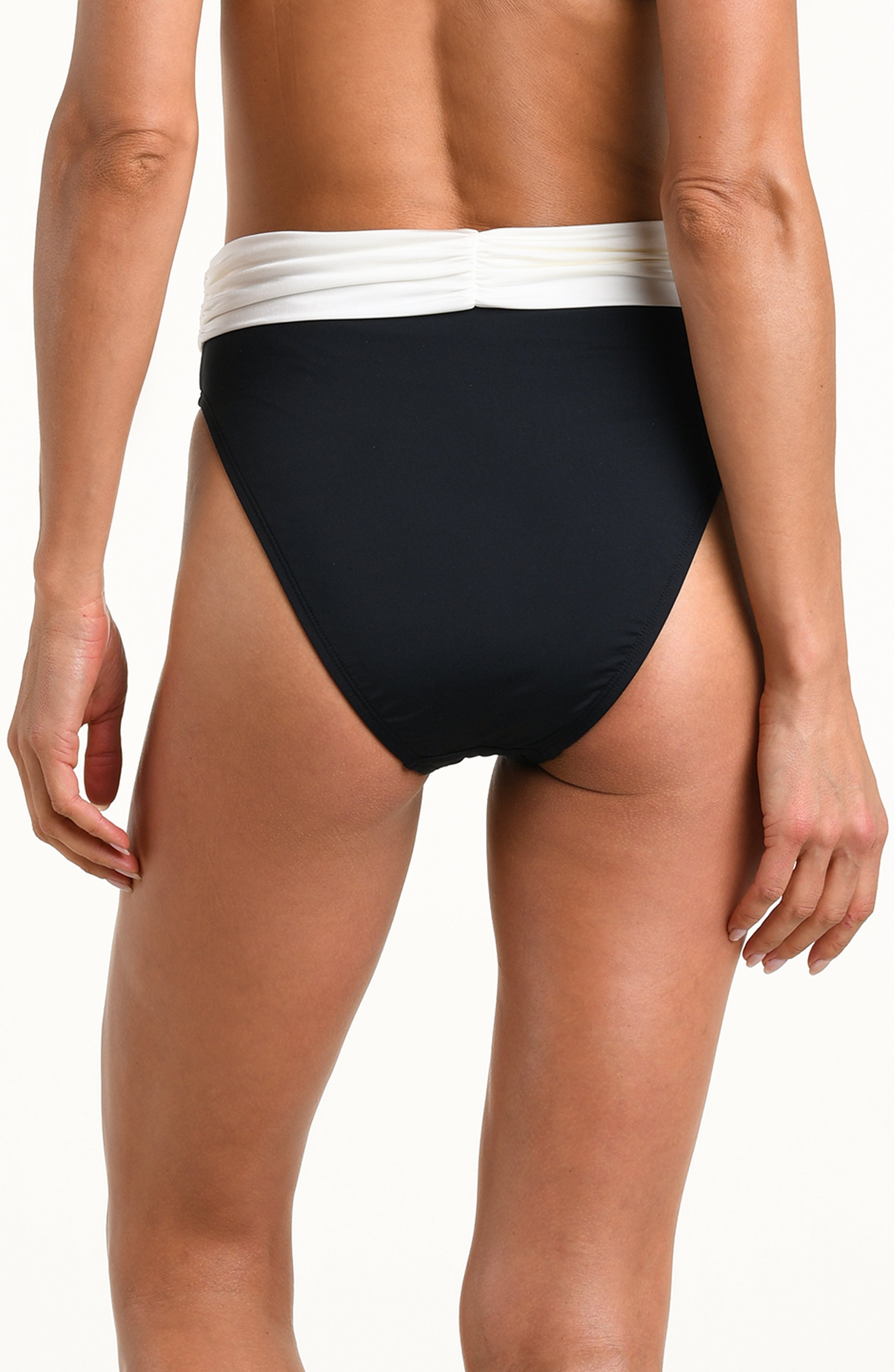 A close-up of a model wearing a pair of high-cut bikini bottoms with a solid black body and a contrasting white waistband, set against a plain white background.