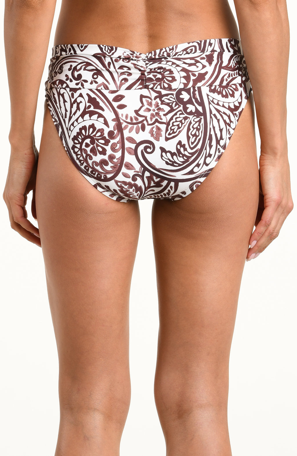 A close-up of a model wearing mid-waisted bikini bottoms with a brown and white paisley pattern, shown against a plain white background.