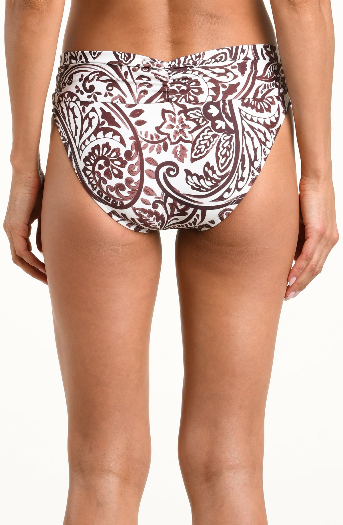 A close-up of a model wearing mid-waisted bikini bottoms with a brown and white paisley pattern, shown against a plain white background.