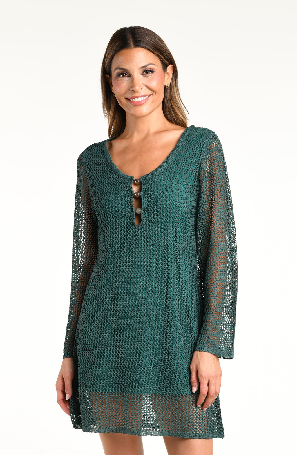 A woman modeling a dark green open-knit long-sleeve mini dress against a plain white background.