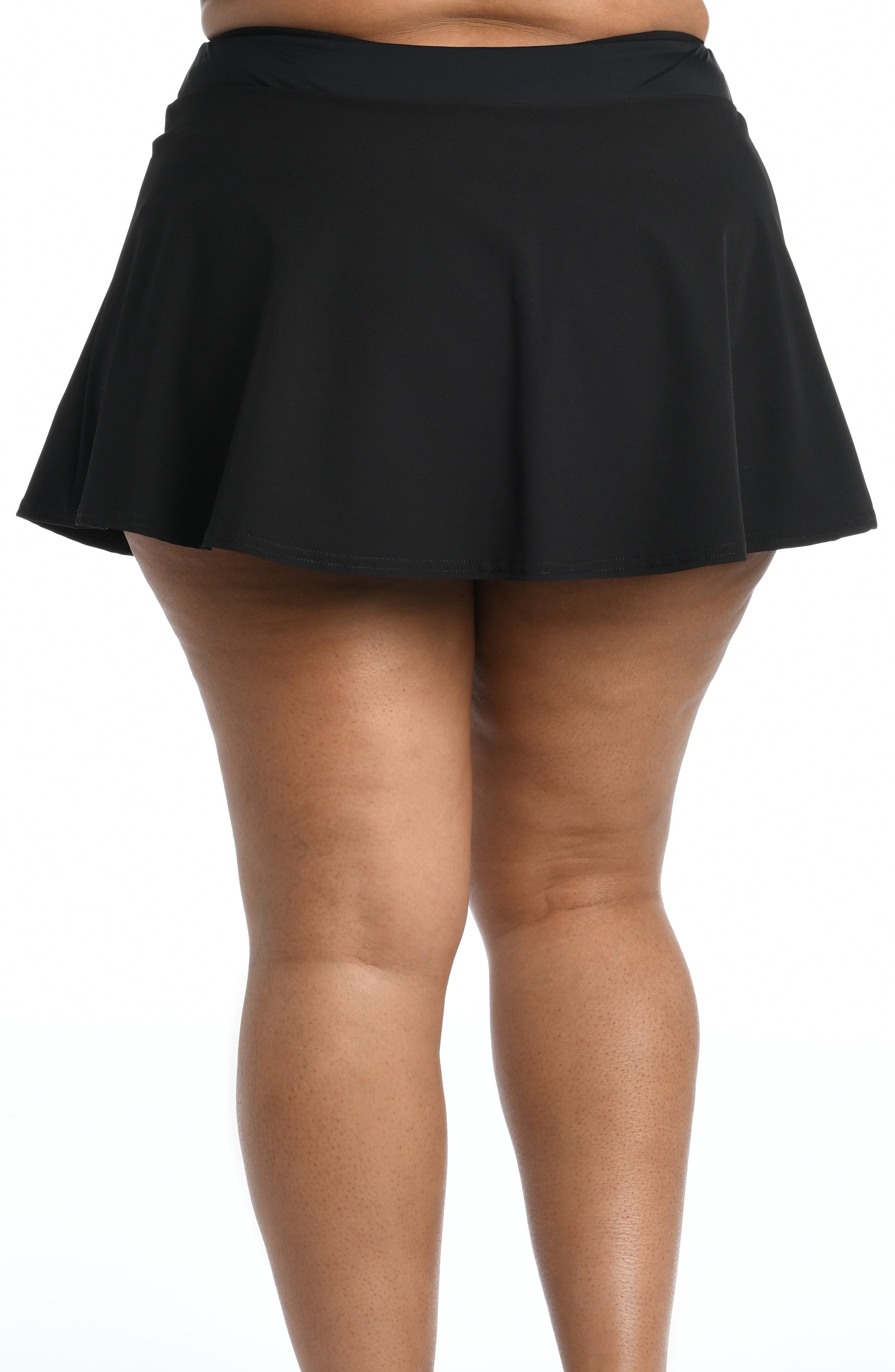 Black swim skirt worn by a person on a white background