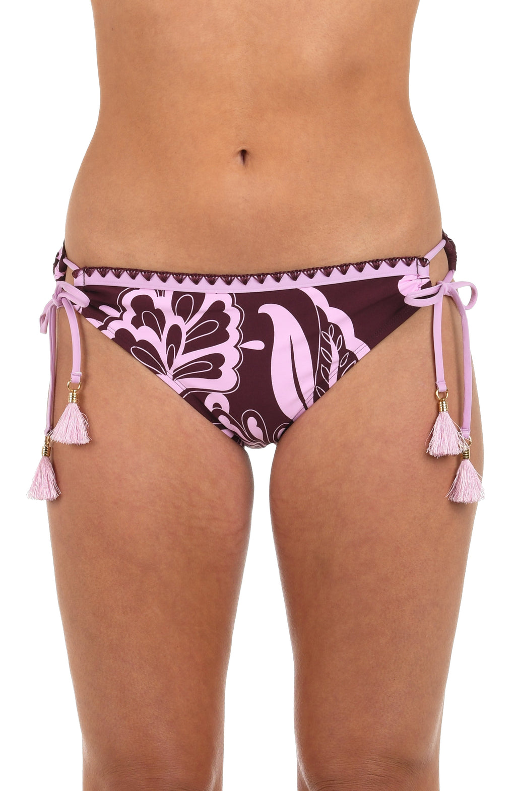Front image of model wearing hipster bikini bottoms with side ties and tassels, in a bold pink and maroon floral print. 