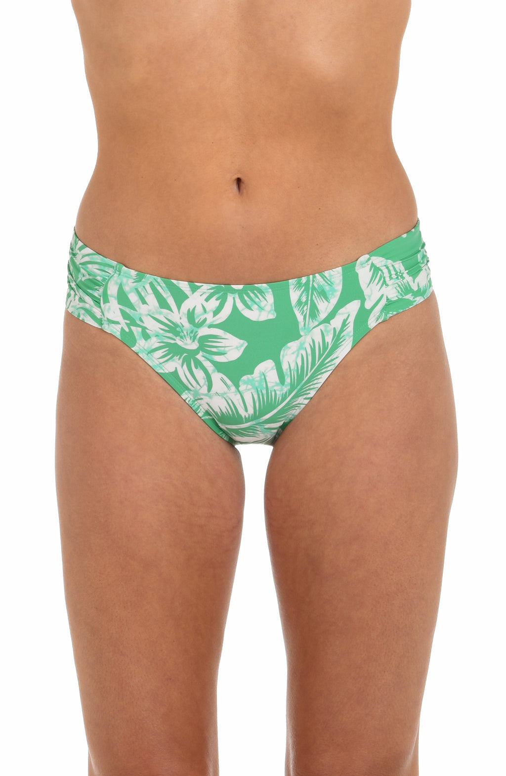 Front image of model wearing a green and white floral-printed hipster bikini bottom featuring shirred sides. 