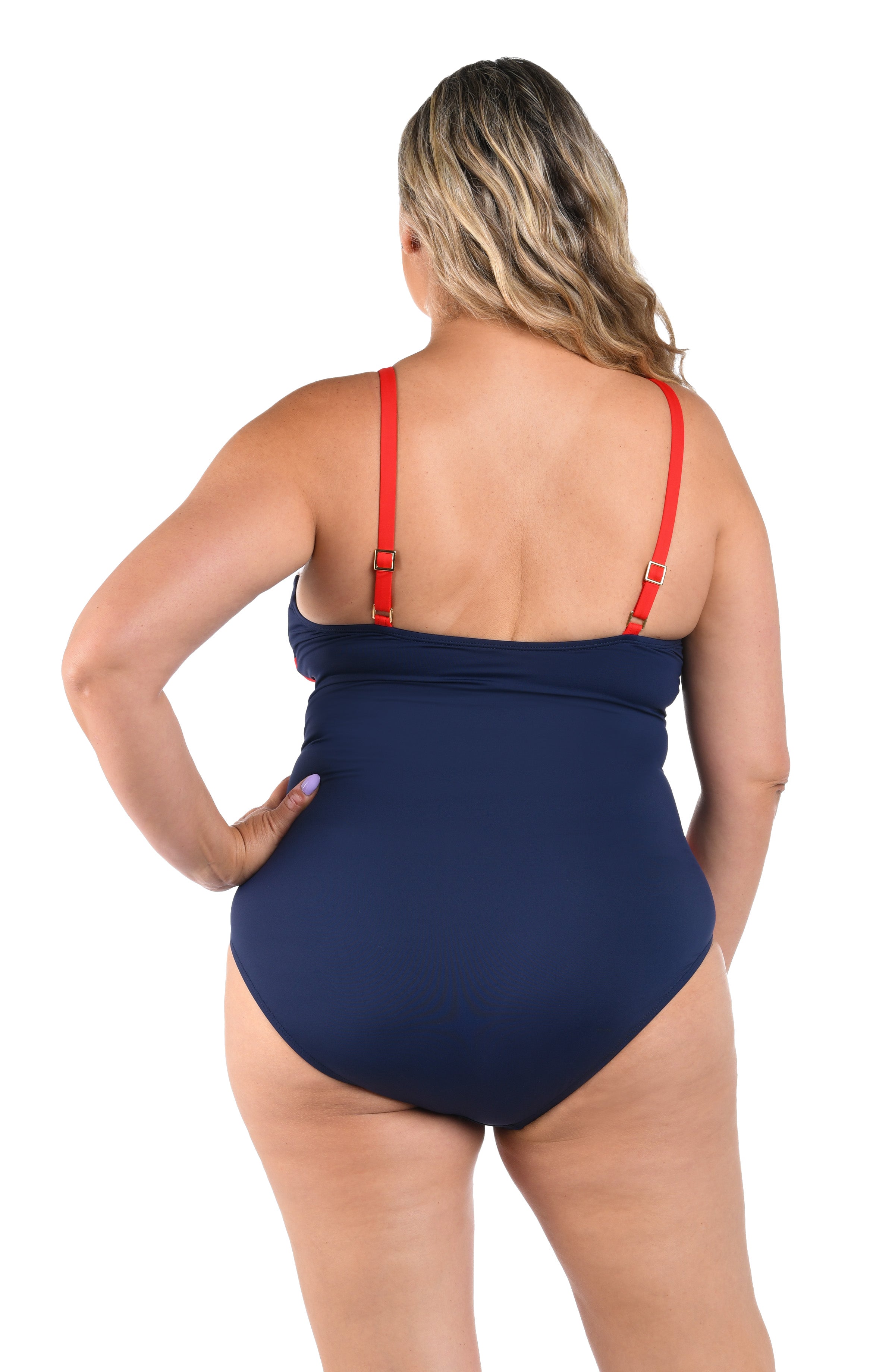 Woman wearing a red, white, and blue one piece swimsuit against a white background.