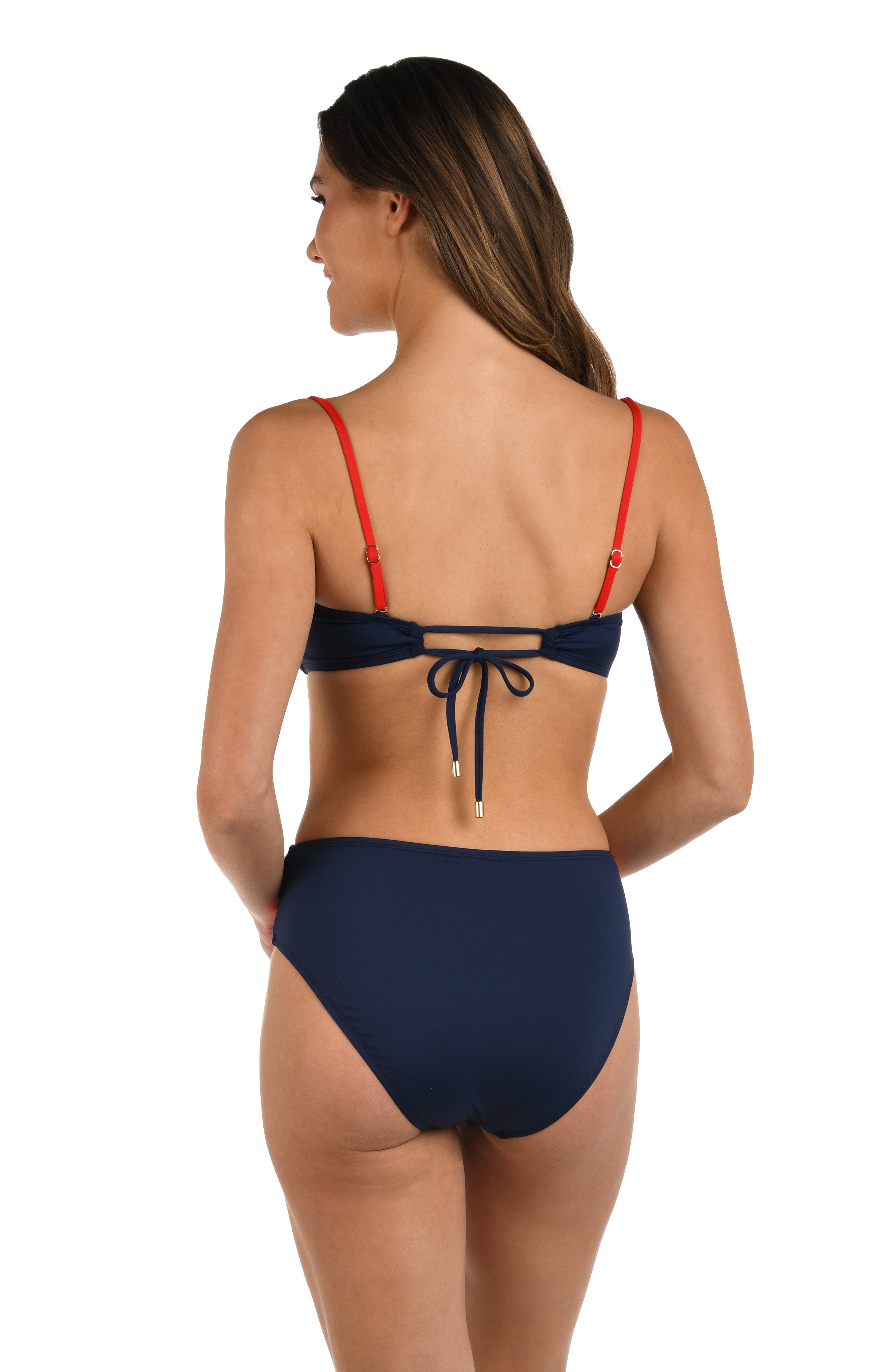 Woman wearing a red, white, and blue color block bandeau bikini top featuring removable straps and a knotted front. 