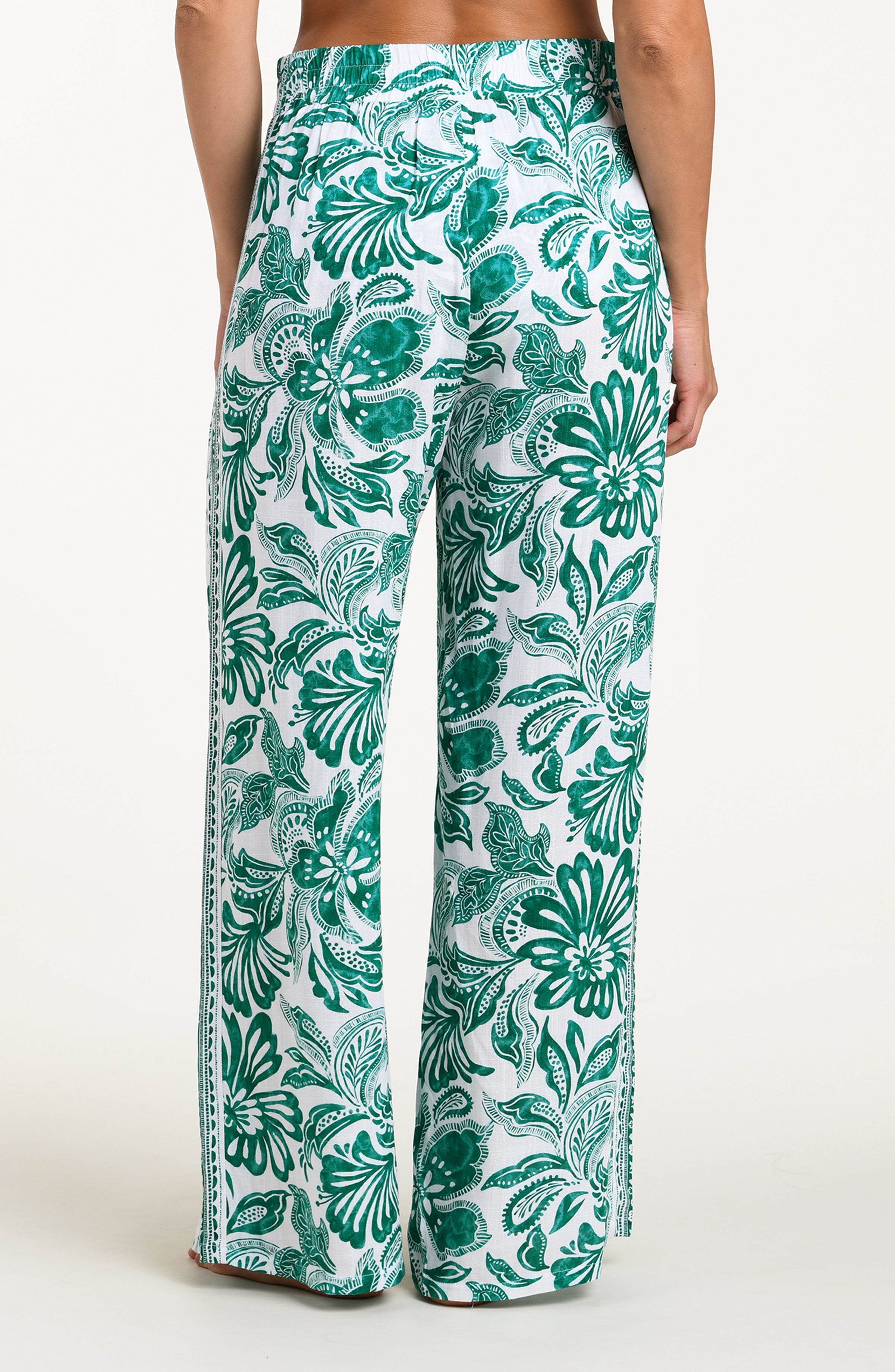 Green and white patterned pants on a white background