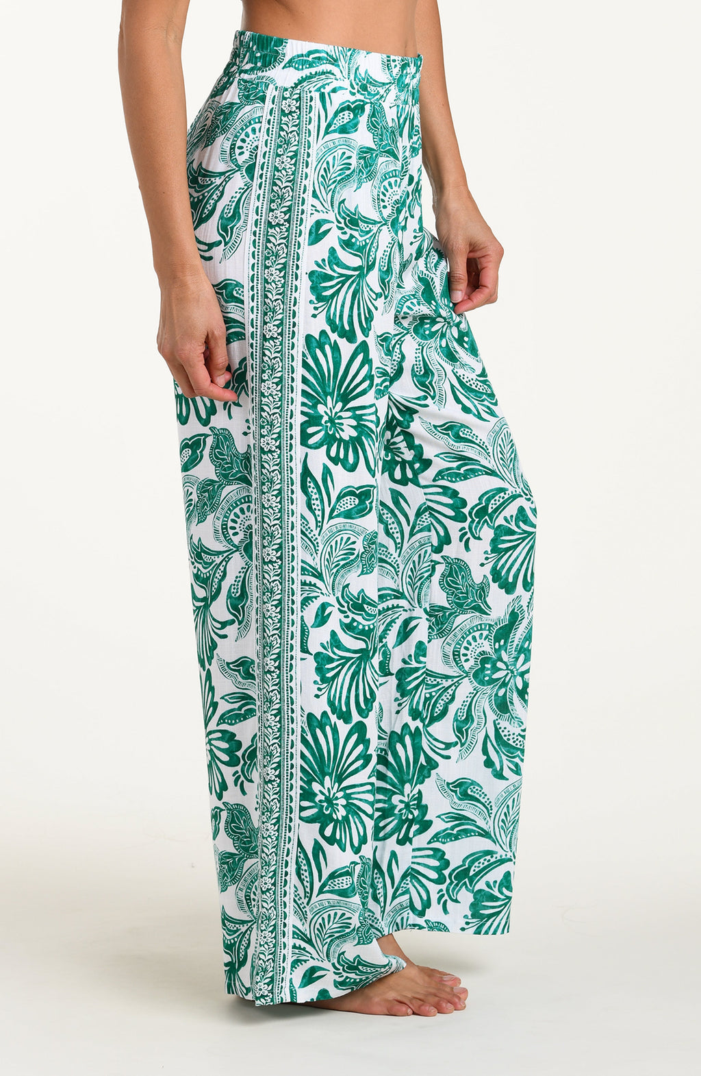 Green floral patterned pants on a white background