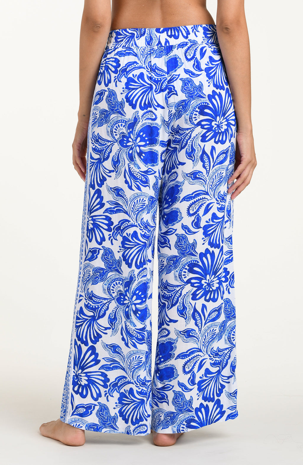 Blue and white floral patterned pants on a plain background