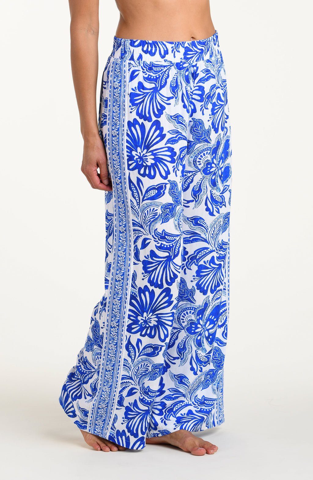 Blue floral patterned pants on a white background