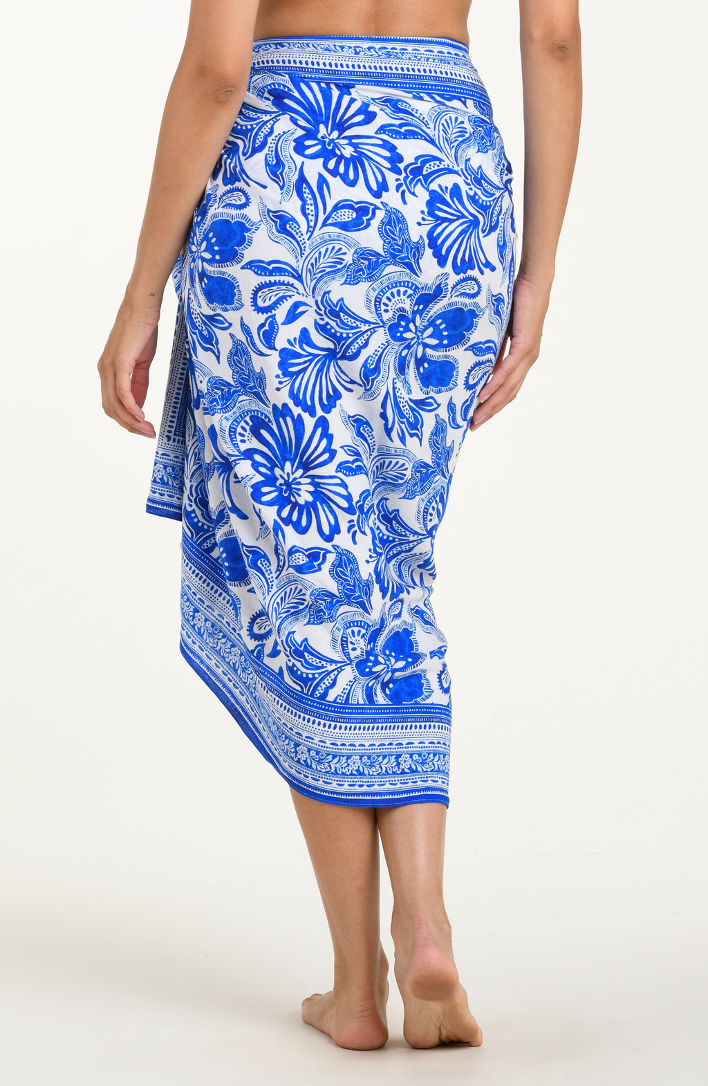 Blue floral patterned sarong worn by a person on a white background