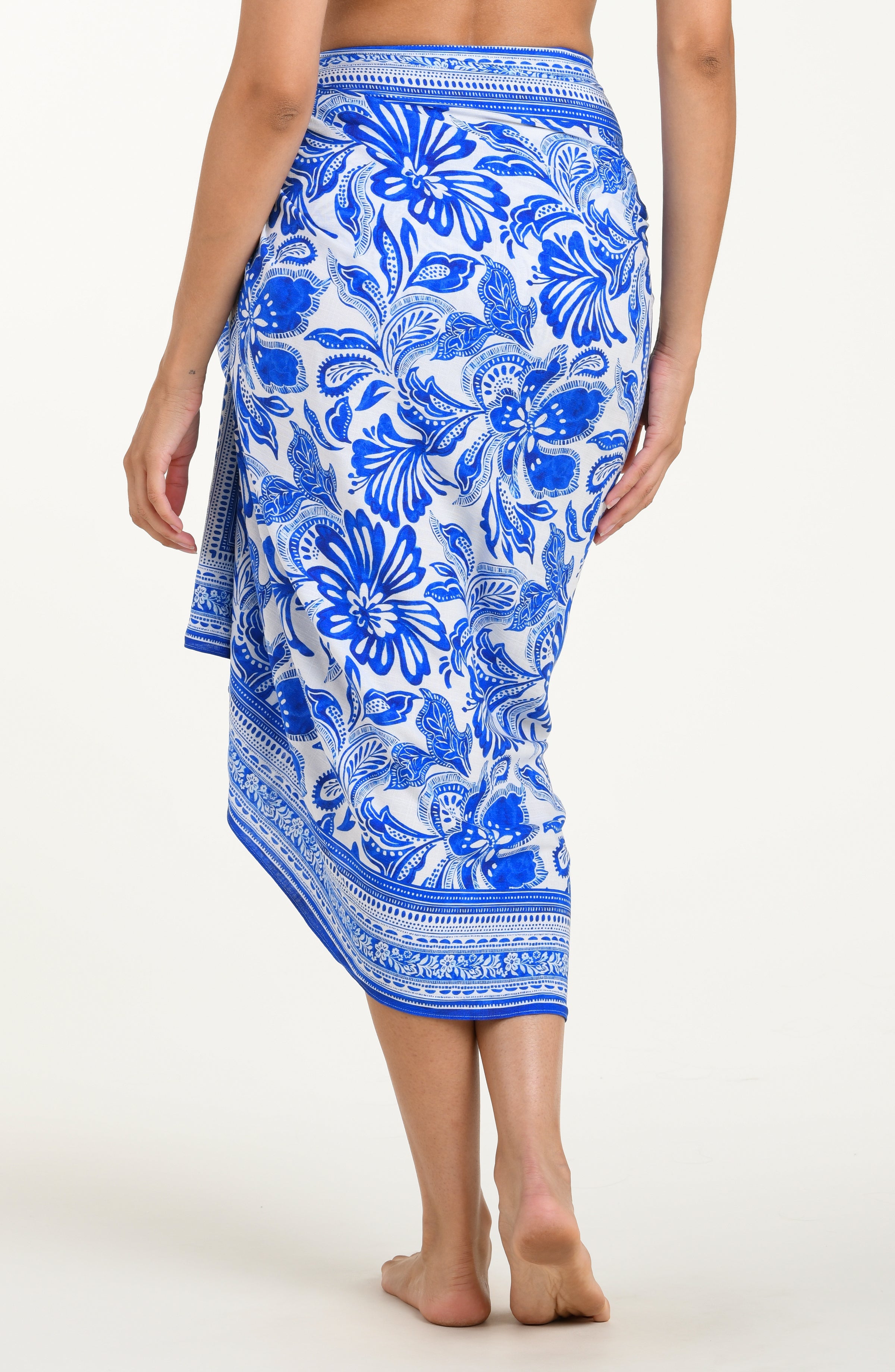 Blue floral patterned sarong worn by a person on a white background