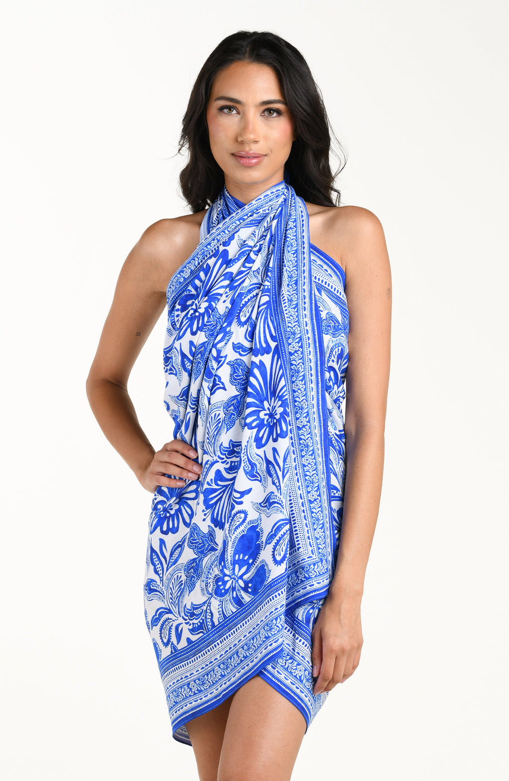 Woman wearing a blue and white floral patterned sarong on a white background