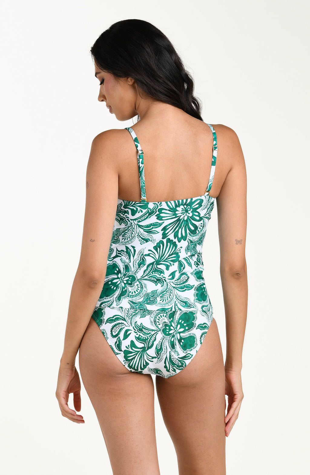 Woman wearing a green and white patterned tankini top and matching bottoms on a white background