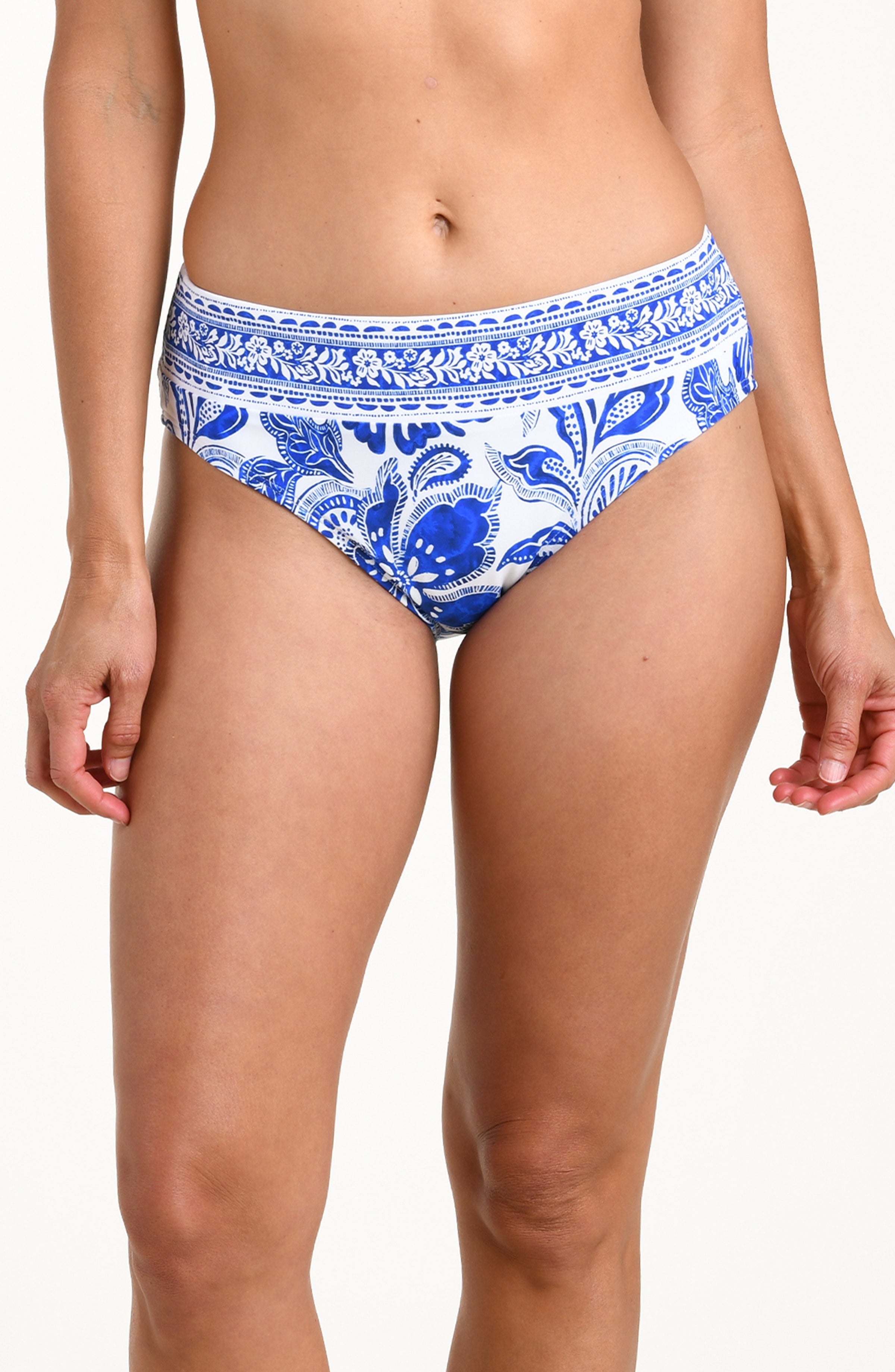 Blue and white patterned bikini bottom worn by a person on a plain background