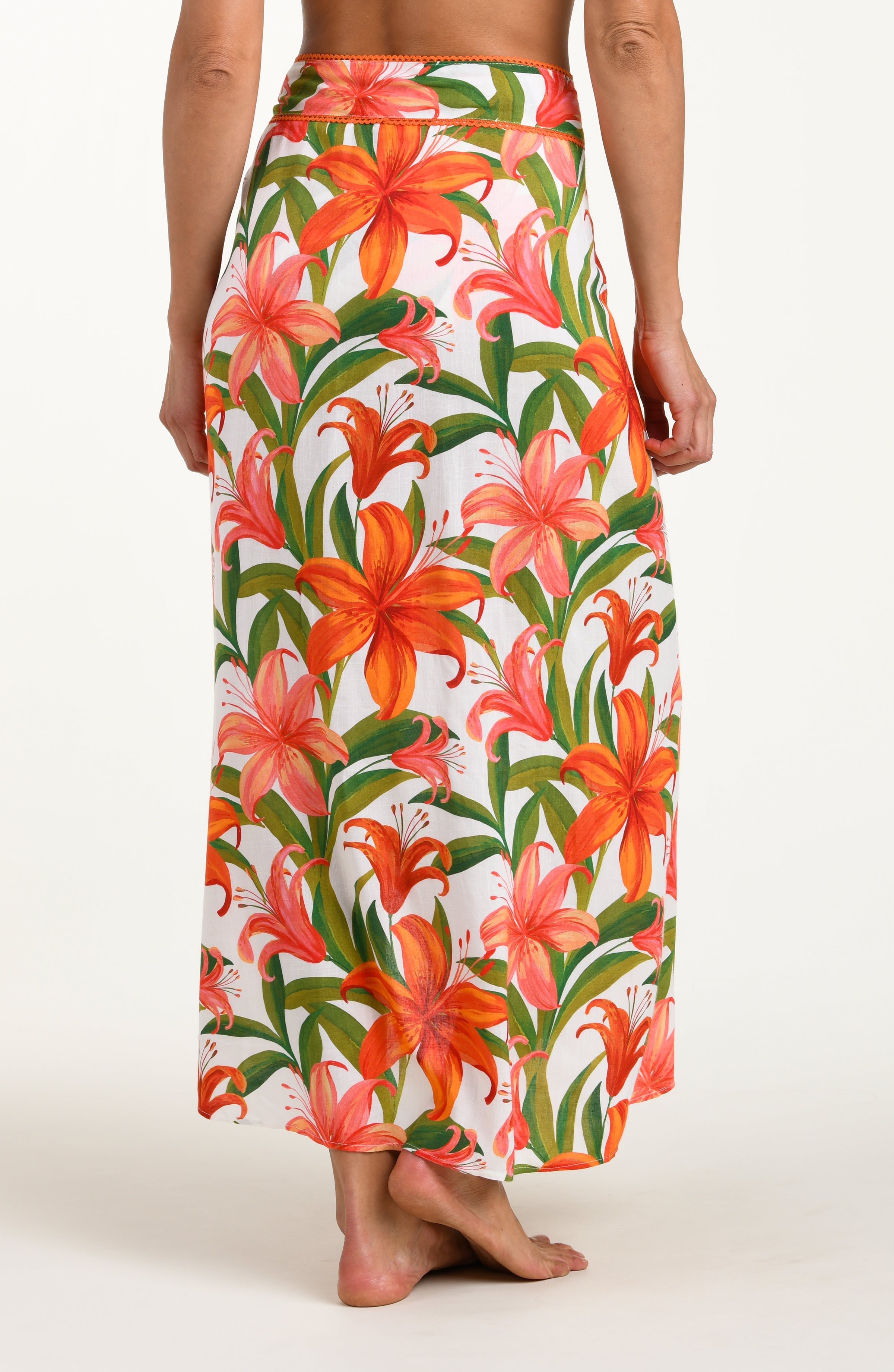 Floral patterned pareo wrap with orange and pink flowers on a white background