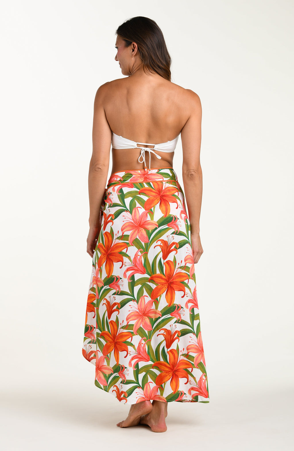 Floral patterned pareo wrap with orange and pink flowers on a white background