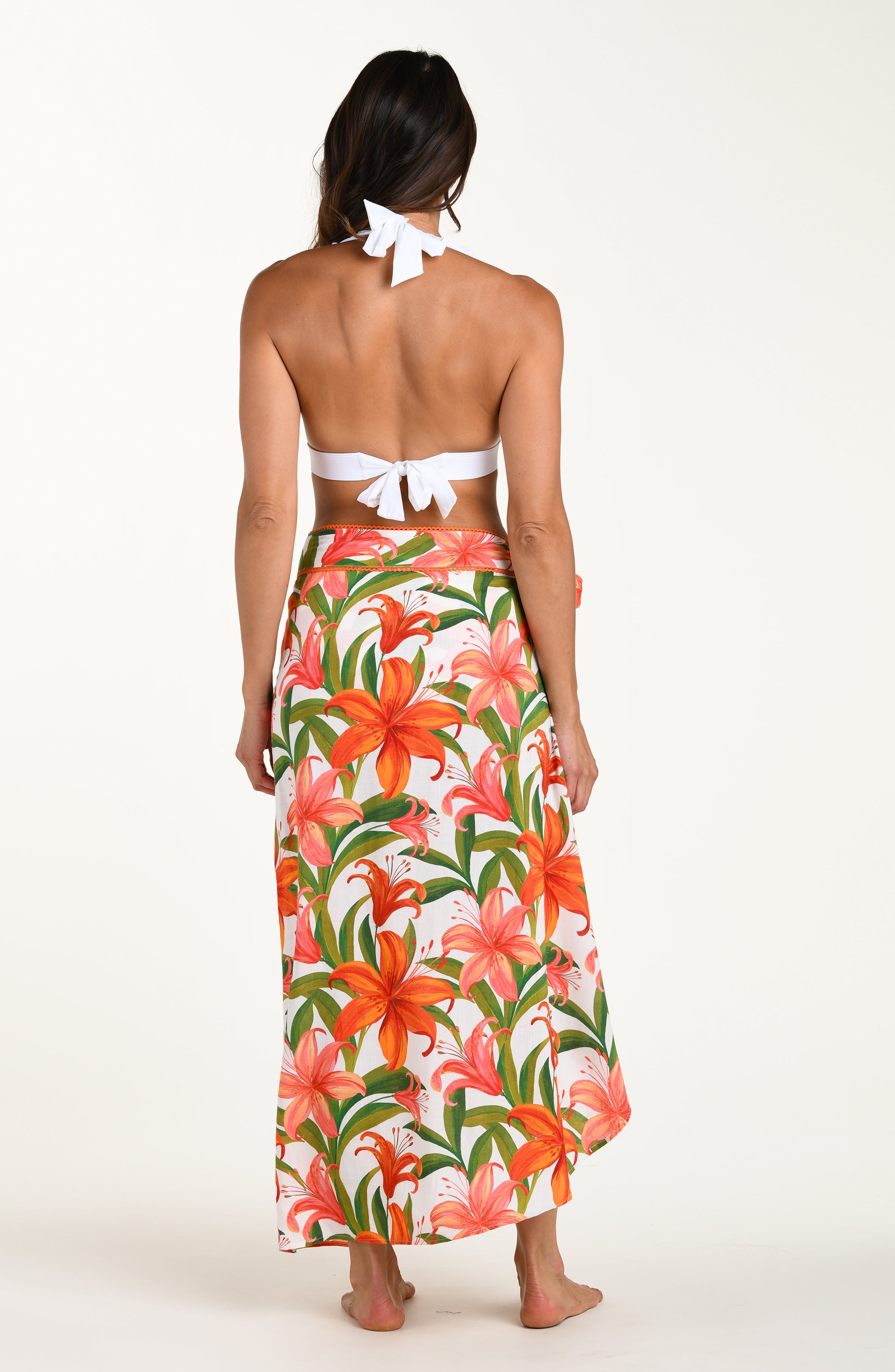 Floral patterned pareo wrap with orange and pink flowers on a white background