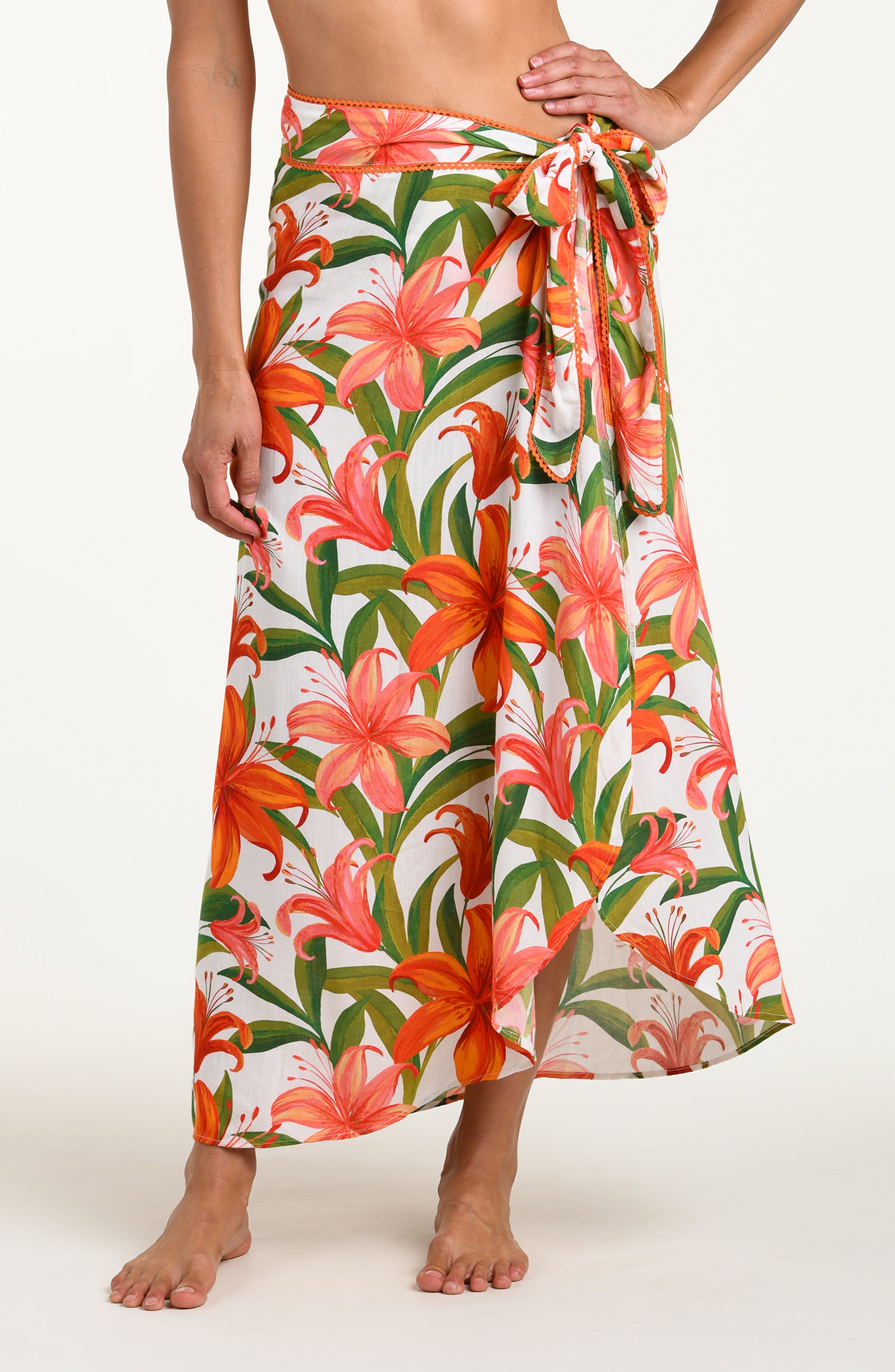 Floral patterned pareo wrap with orange and pink flowers on a white background