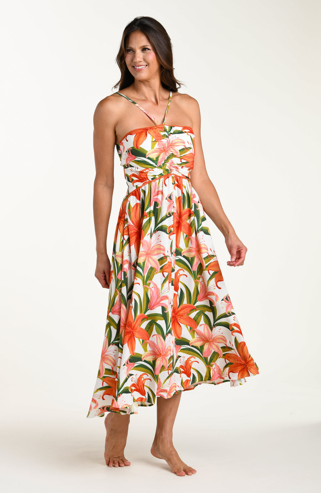 Woman wearing a floral cover up dress on a white background