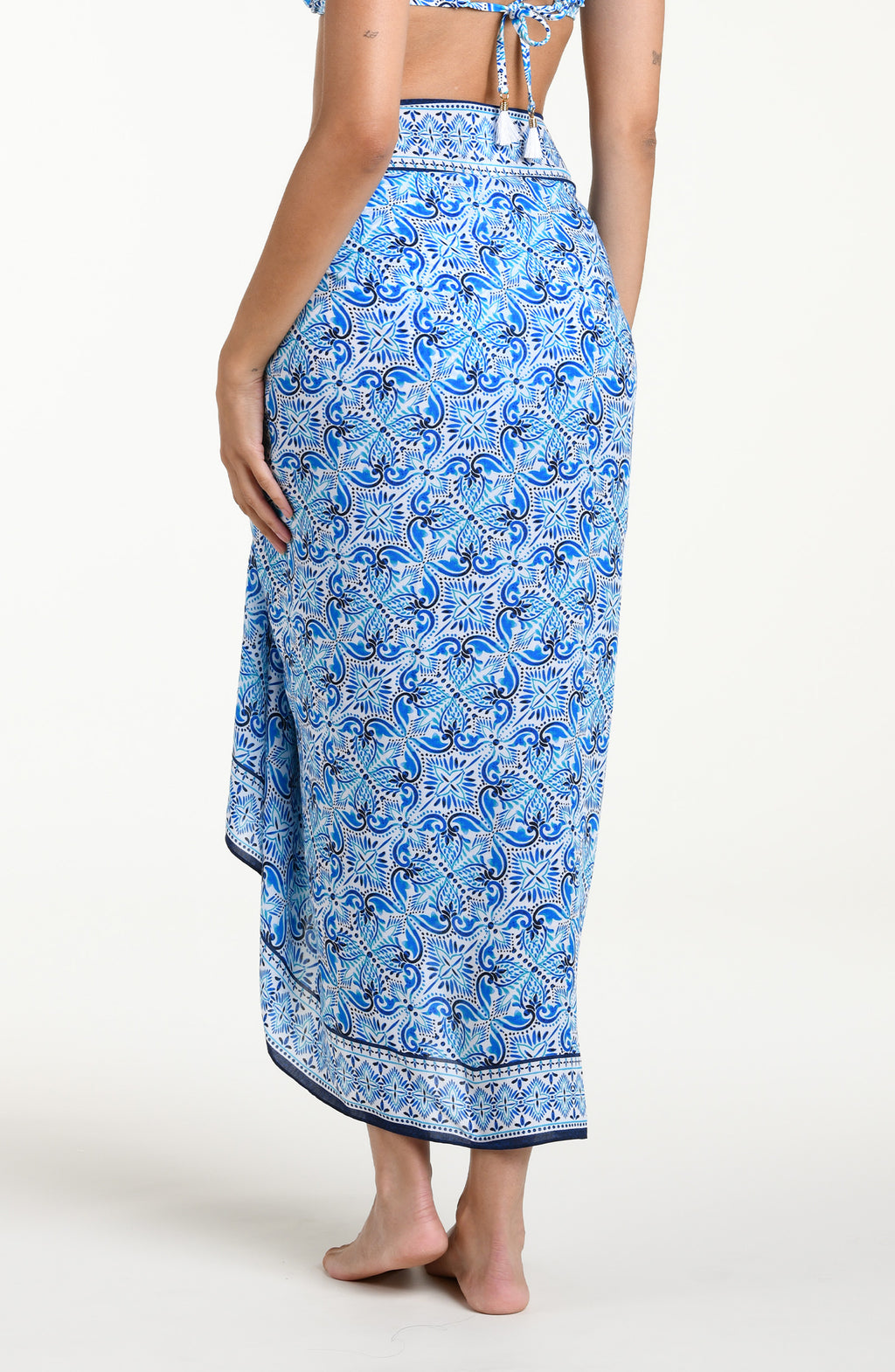 Blue floral patterned pareo wrap against a white background