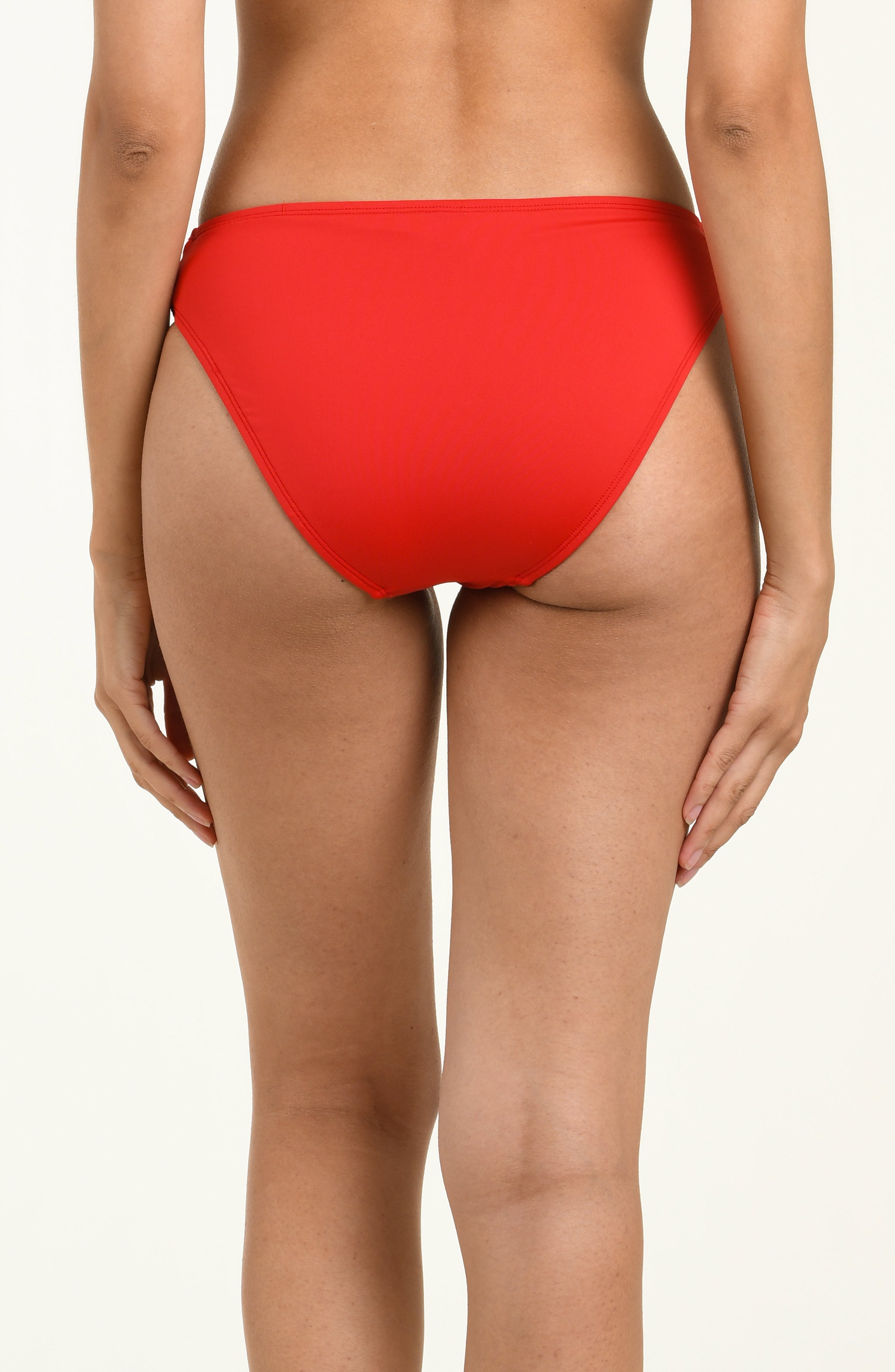 Red bikini bottom with white floral pattern on a plain background