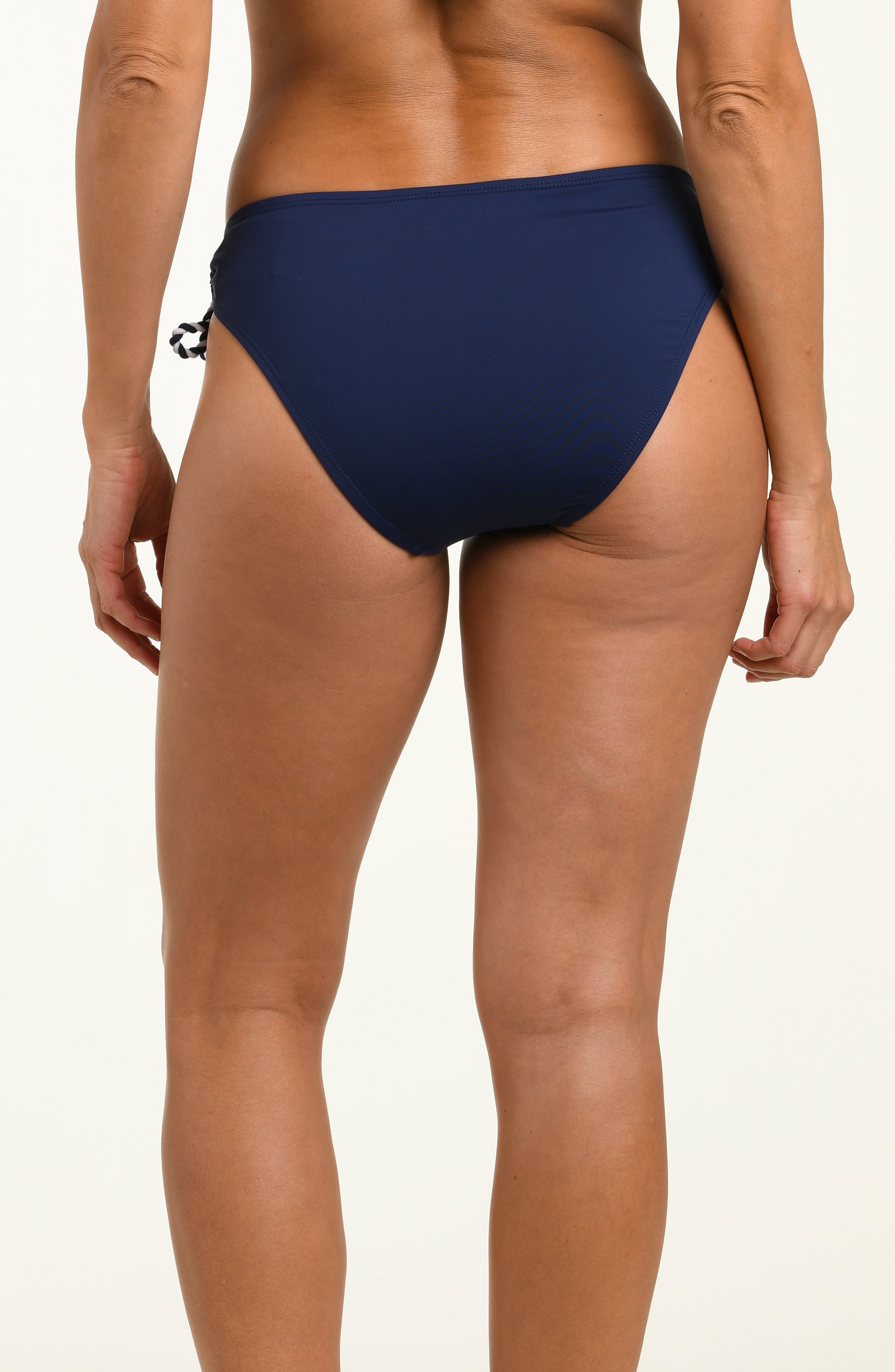Navy blue bikini bottom worn by a person on a white background
