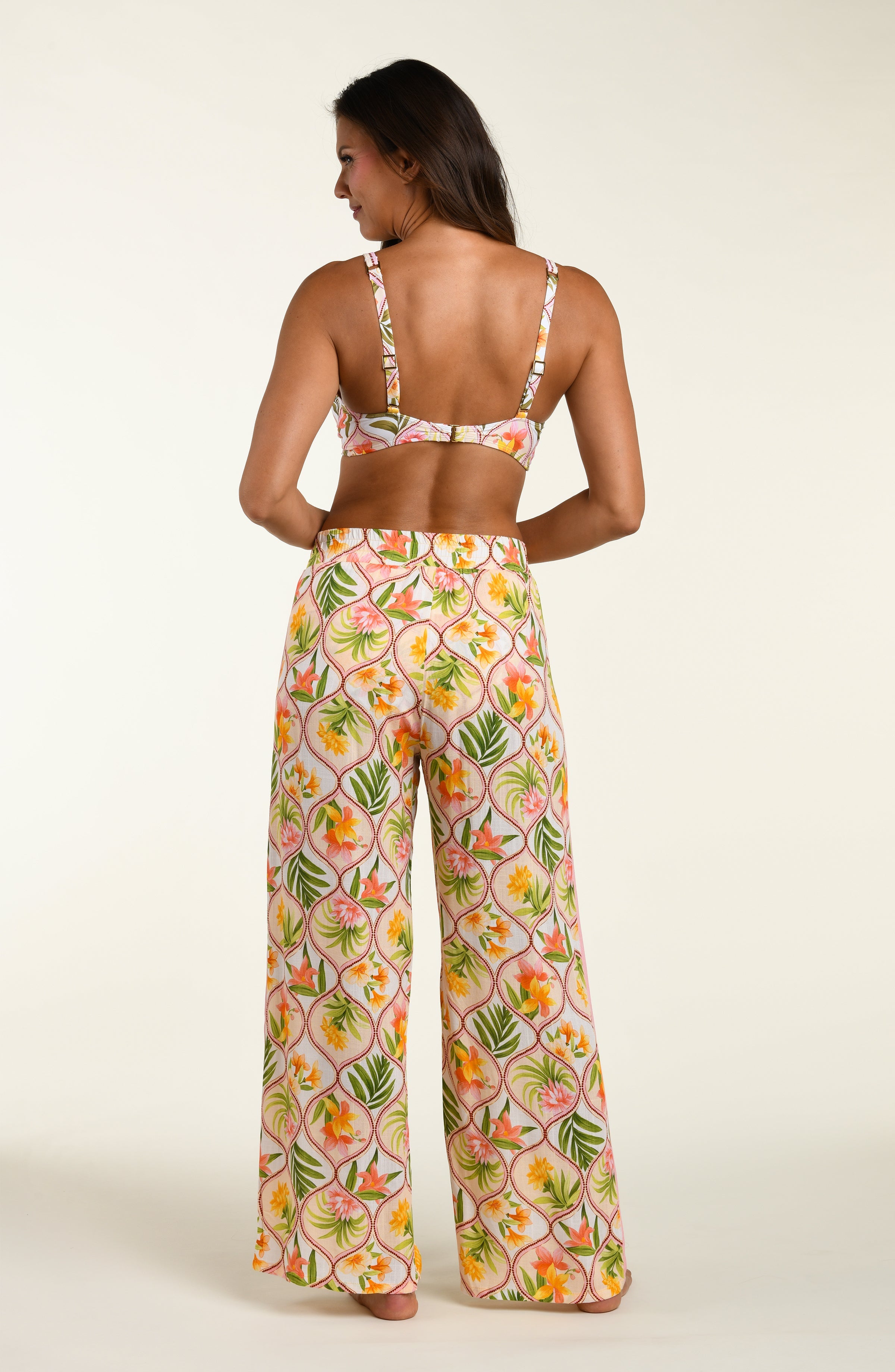 Floral patterned pants and matching bikini top worn by a person on a white background