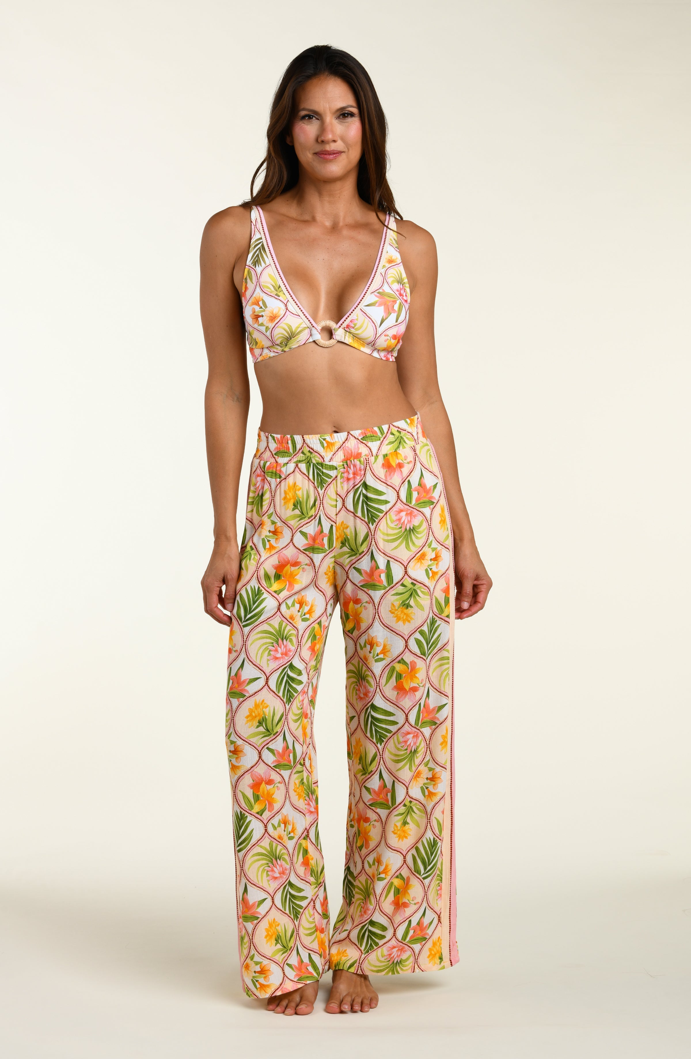 Floral patterned pants and matching bikini top worn by a person on a white background