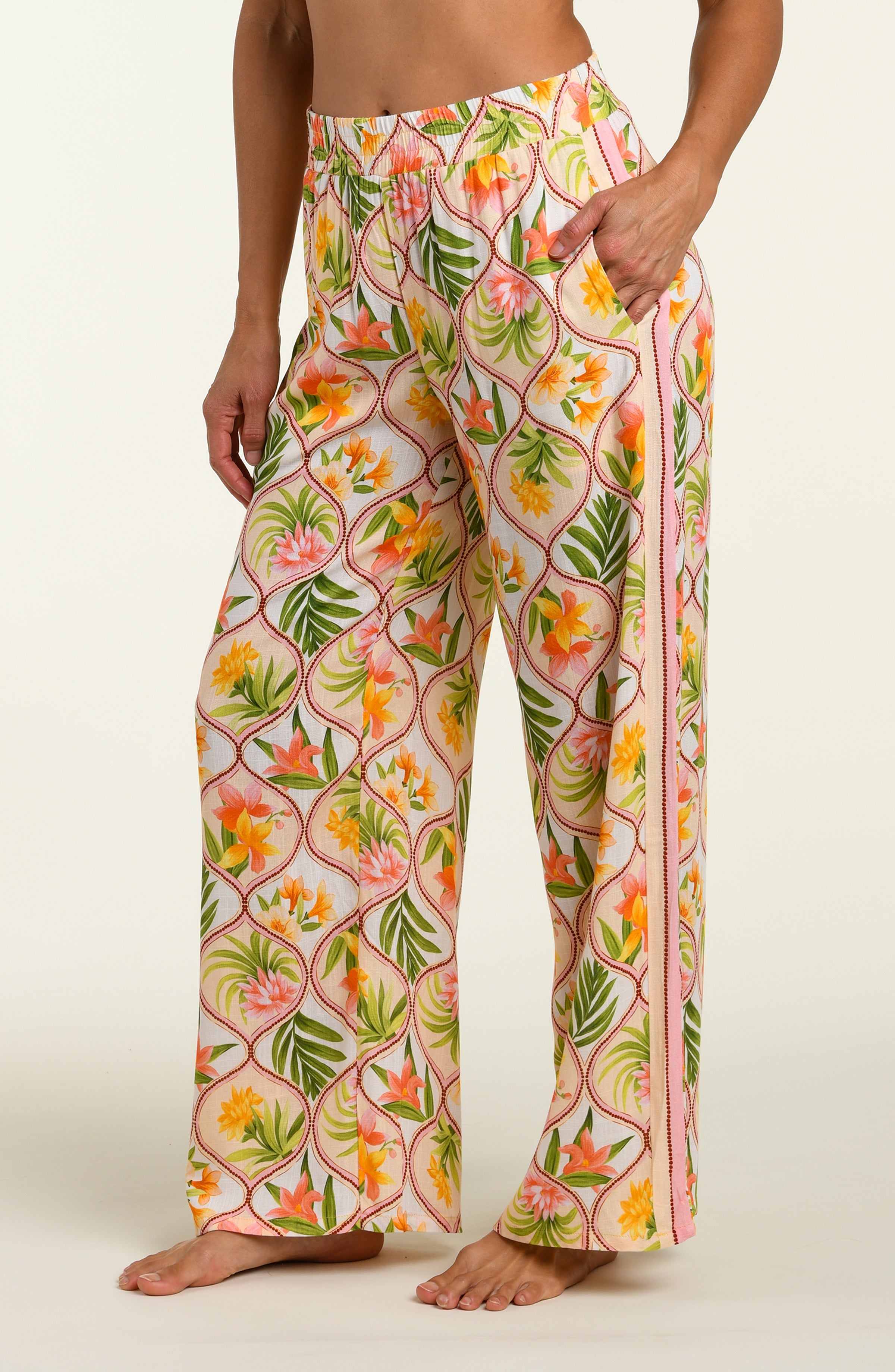 Floral patterned pants worn by a person on a white background