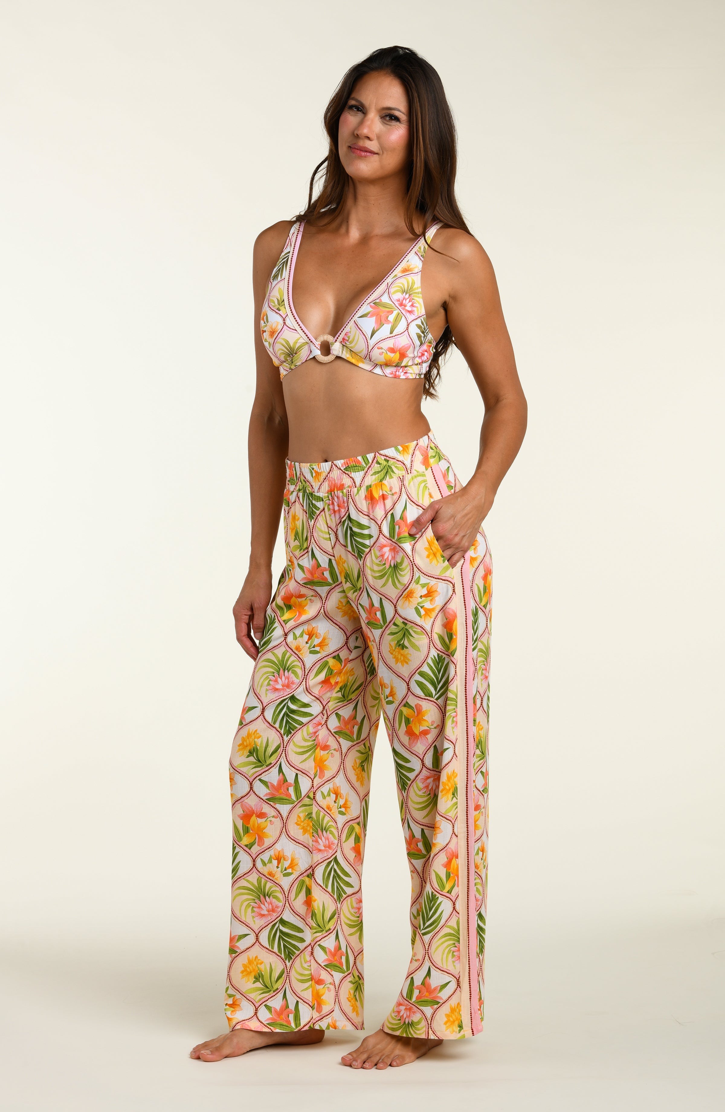 Floral patterned pants and matching bikini top worn by a person on a white background