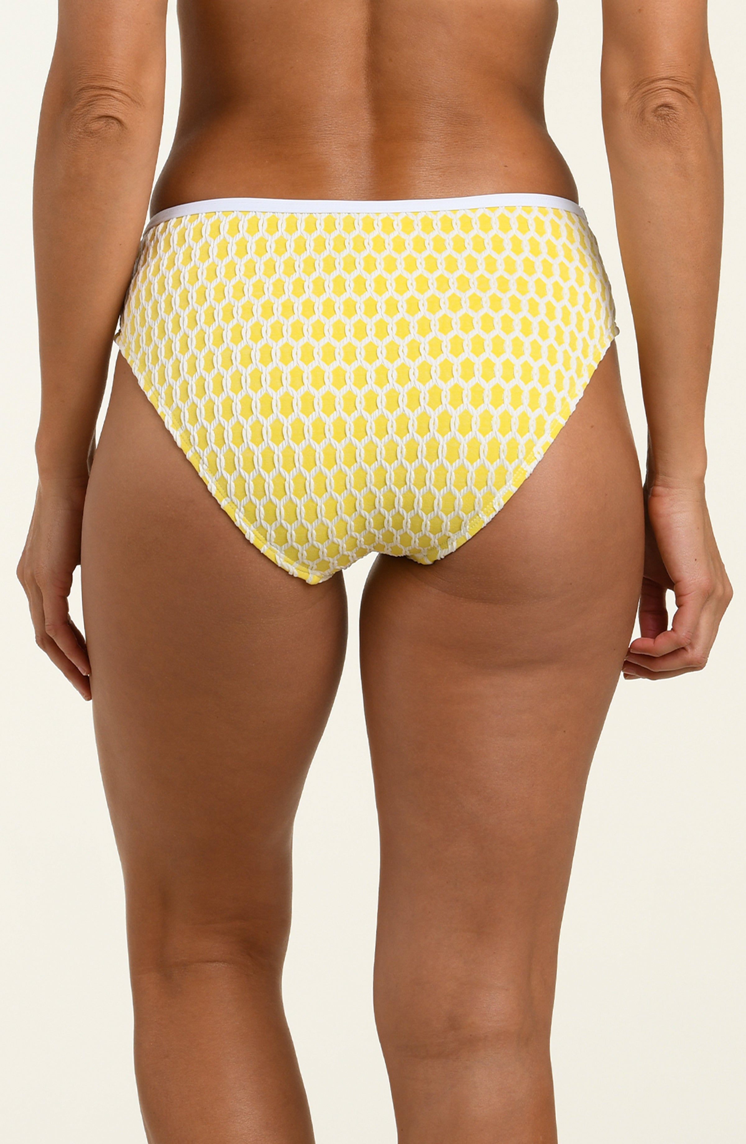 Yellow patterned bikini bottom on a beige background