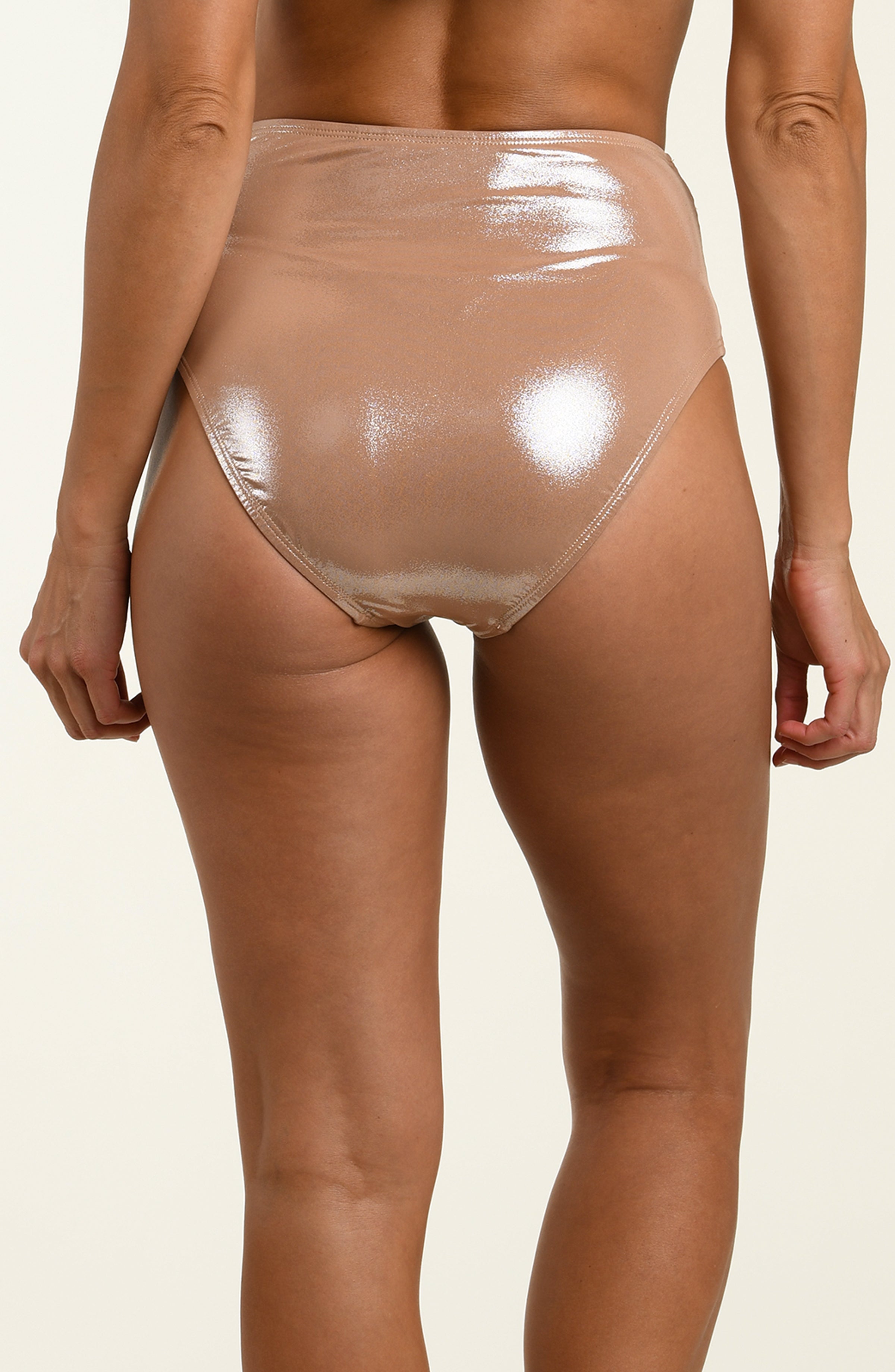 Beige high-waisted bikini bottom with metallic waistband on a beige background