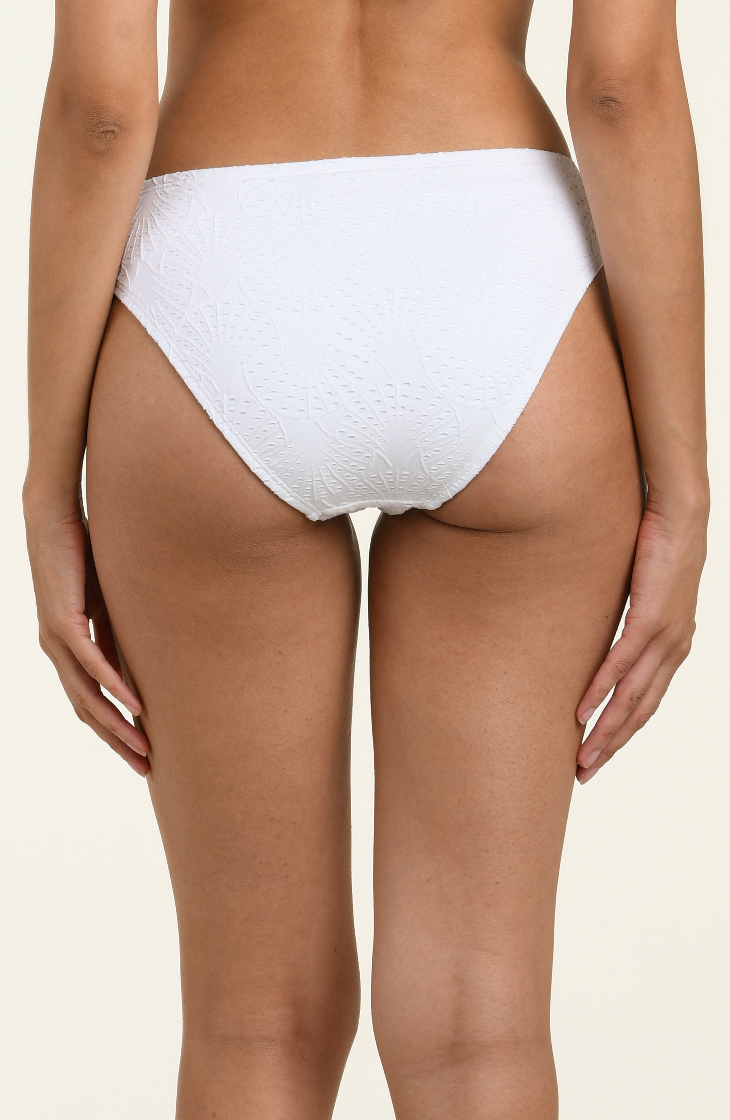 White textured bikini bottom on a beige background