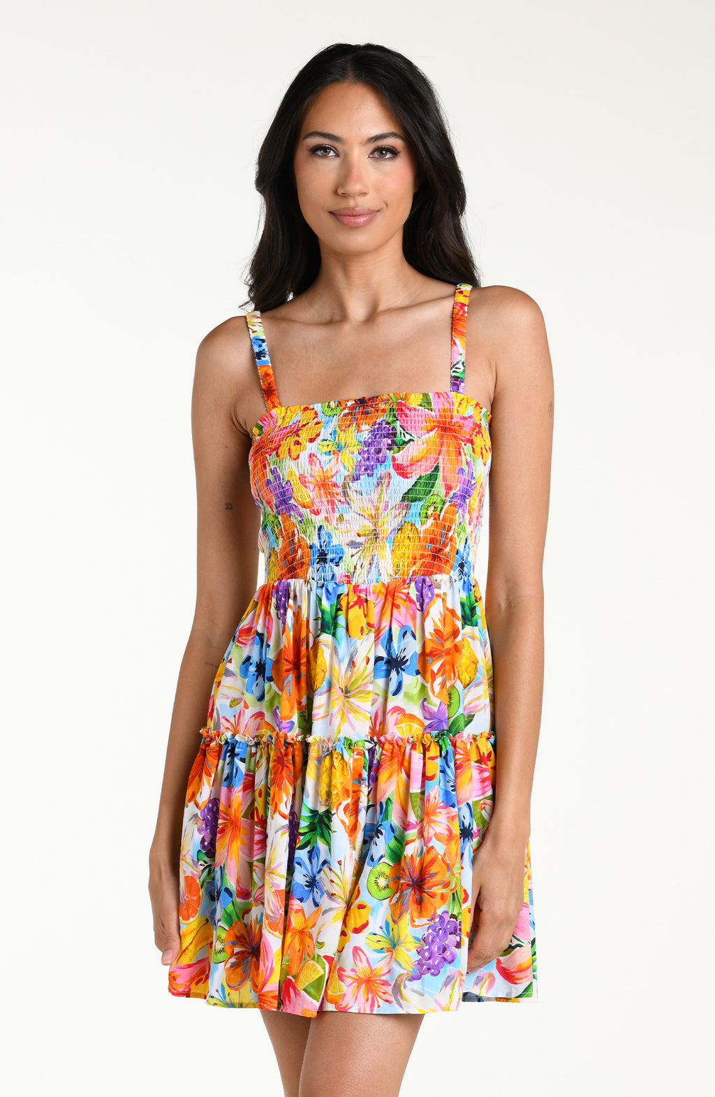 Woman wearing a colorful floral mini dress cover up against a white background