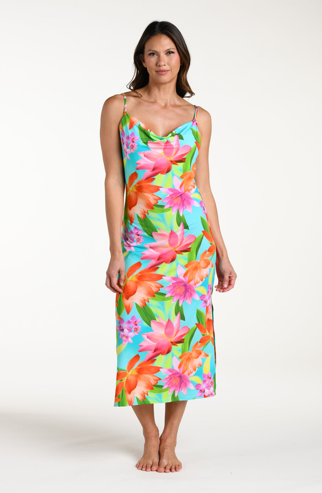 Woman wearing a bright floral midi dress cover up against a white background.