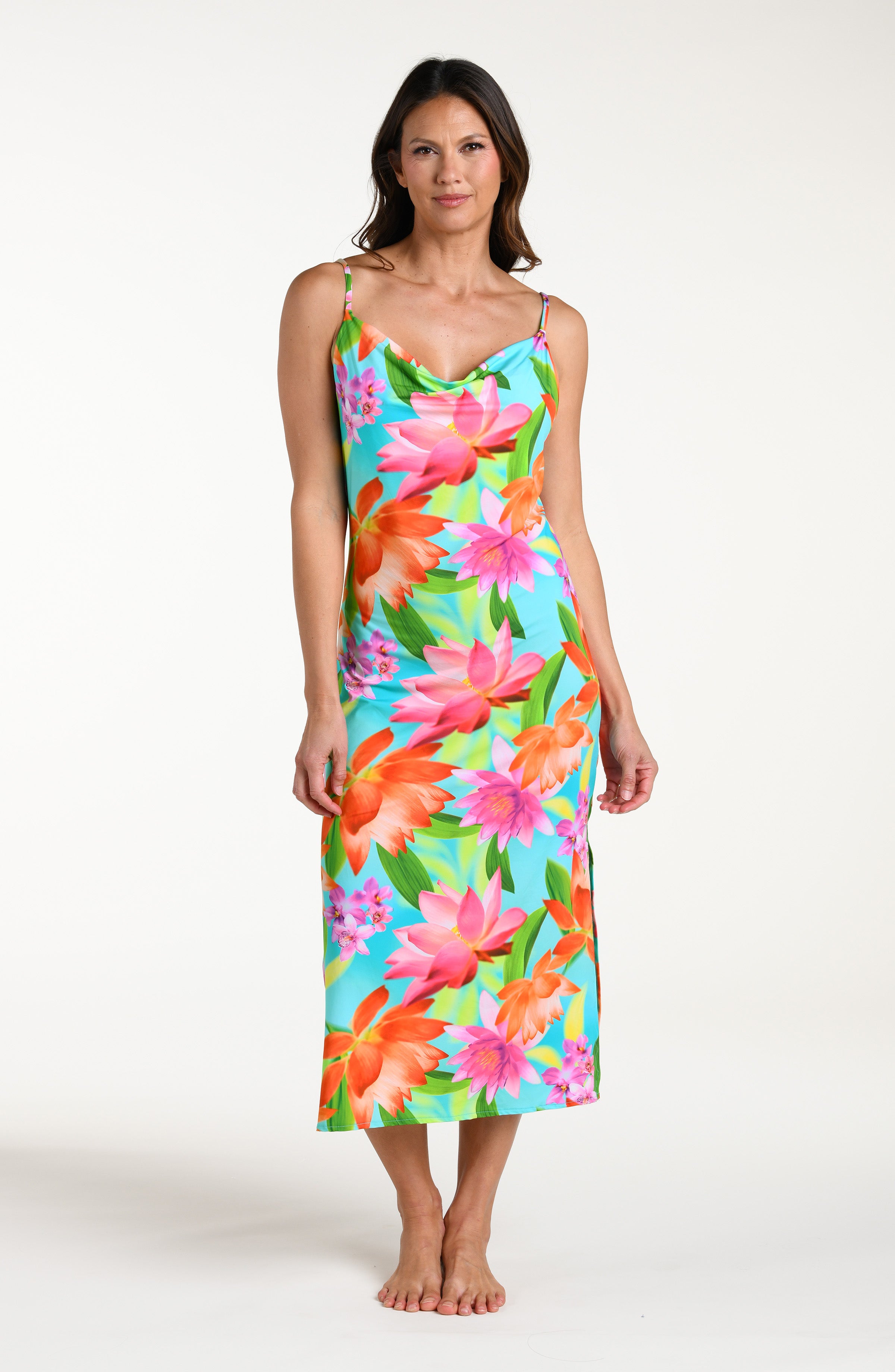 Woman wearing a bright floral midi dress cover up against a white background.