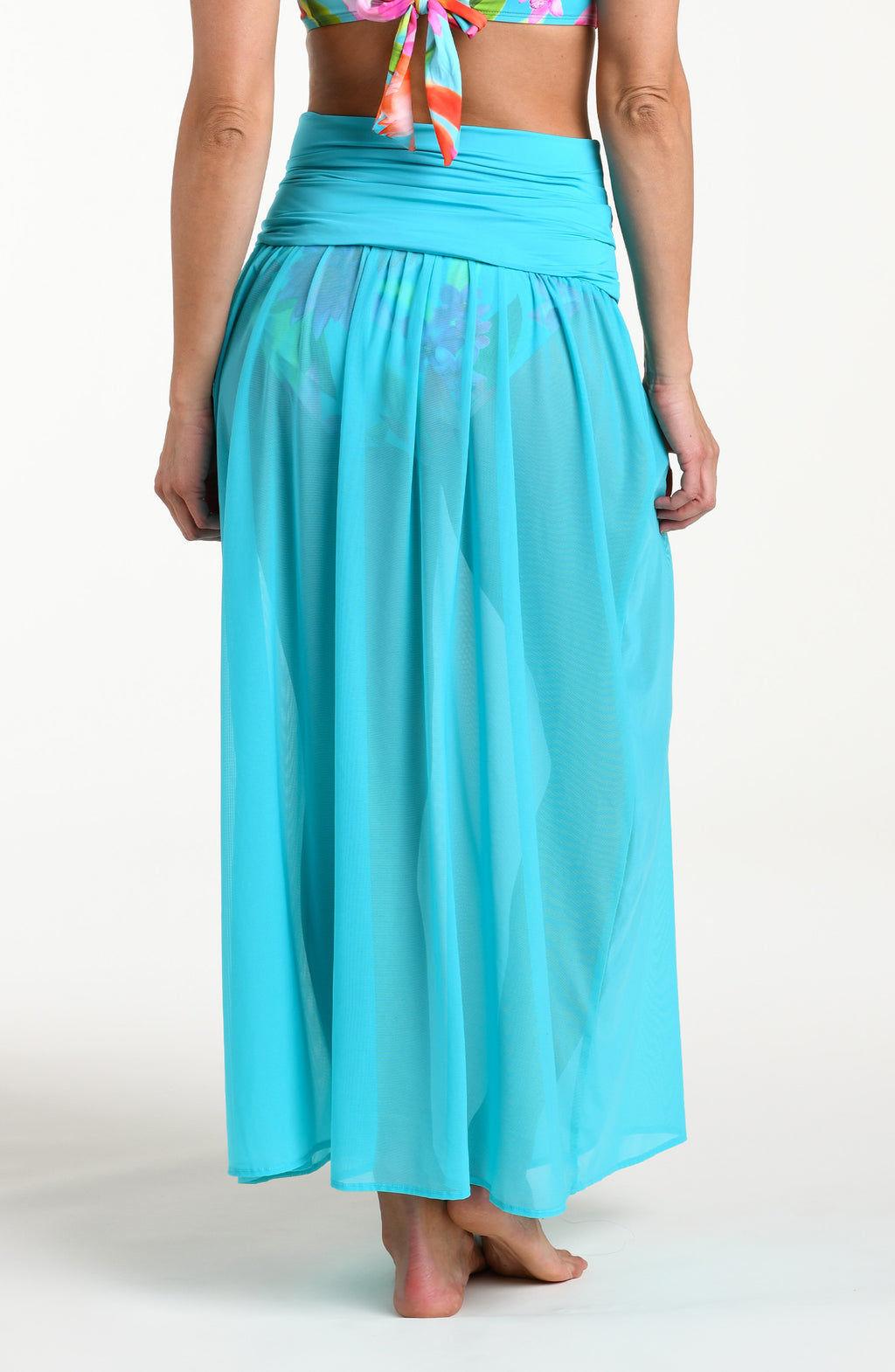 Turquoise skirt worn by a person on a white background