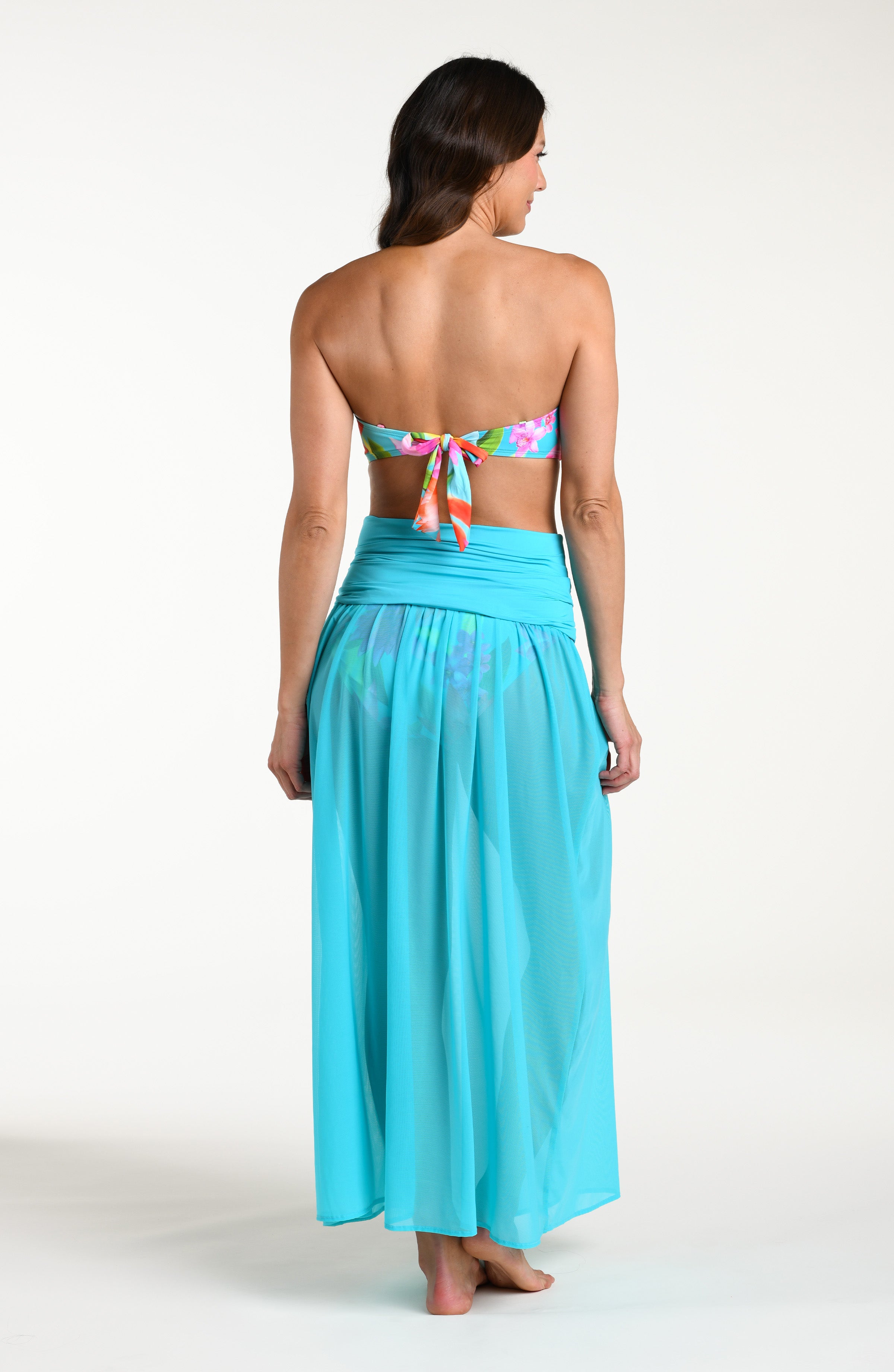 Woman wearing a turquoise convertible maxi dress cover up against a white background