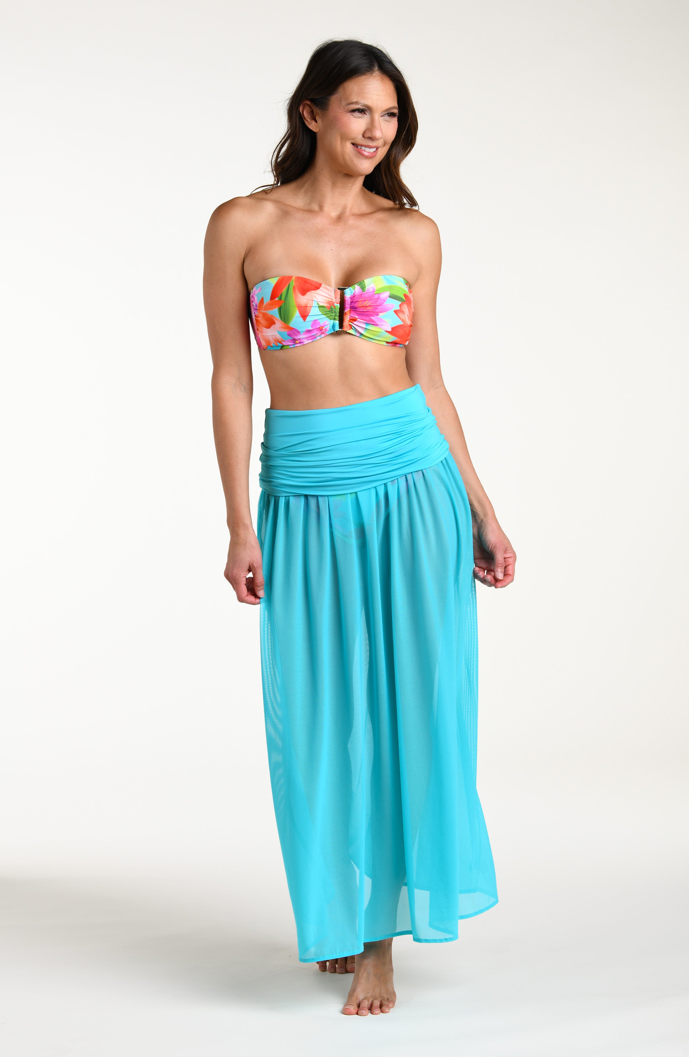 Woman wearing a turquoise convertible maxi dress cover up against a white background