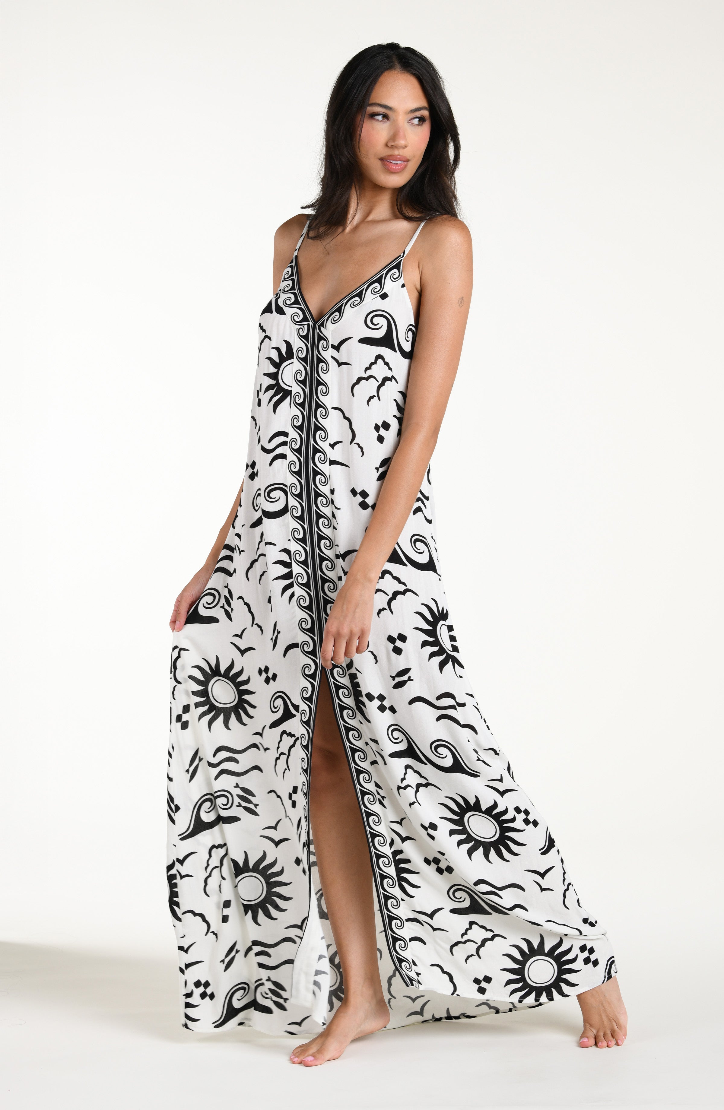 Woman wearing a black and white patterned maxi dress against a white background