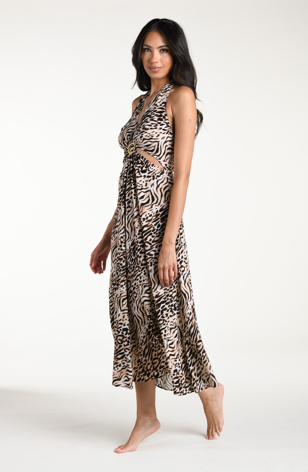 Woman wearing a zebra printed maxi dress cover up against a white background