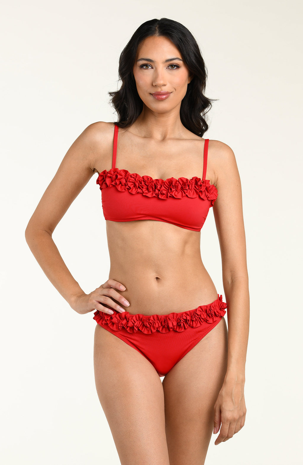 Woman wearing a red bikini top with floral details and a matching bikini bottom on a white background