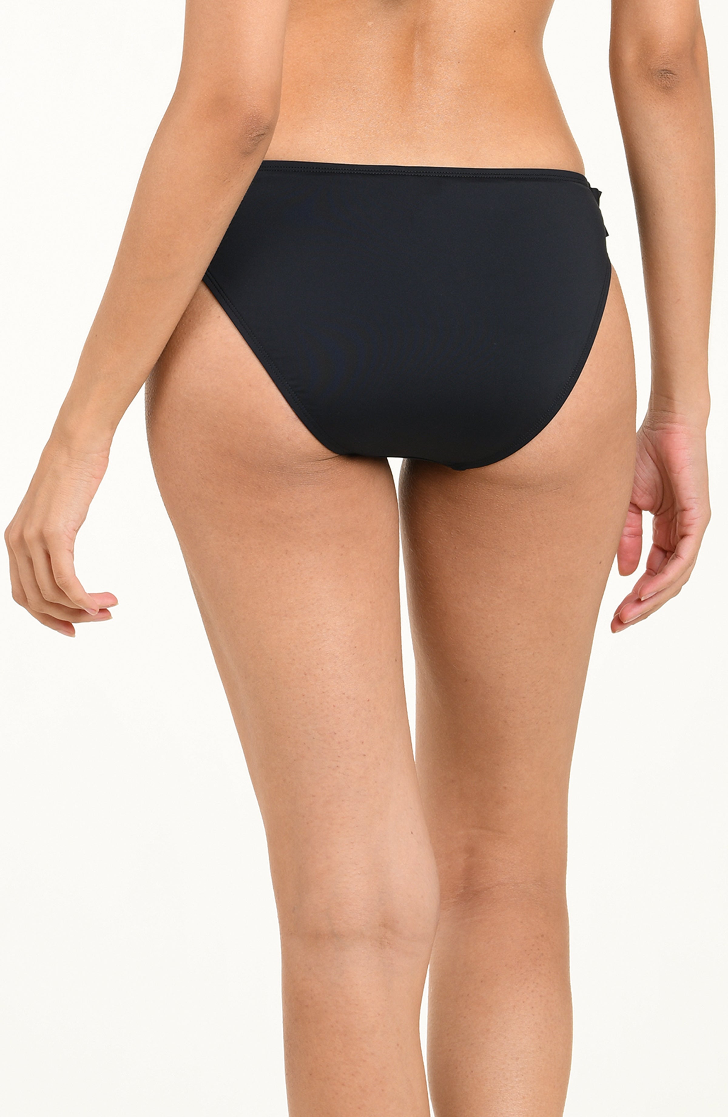 Black bikini bottom with ruffled details on a white background